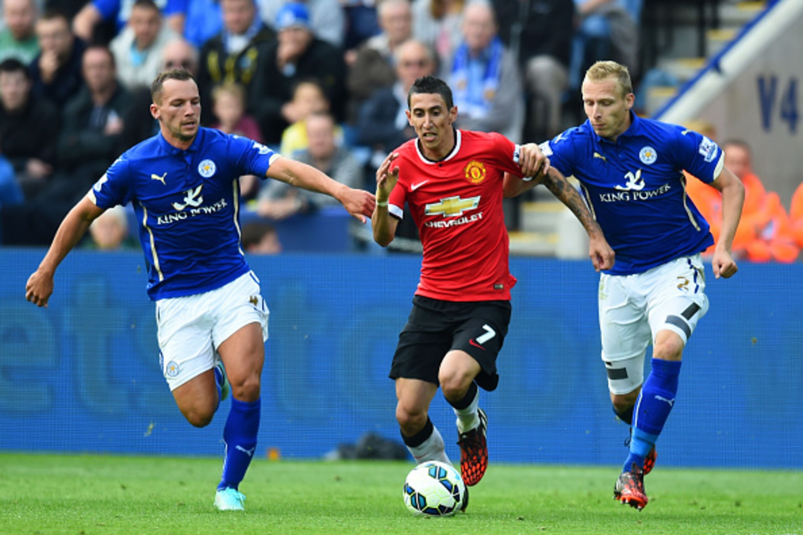 LEICESTER, ENGLAND - SEPTEMBER 21:  Angel di Maria of Manchester United is challenged by Daniel Drinkwater (L) of Leicester City and Ritchie De Laet (R) of Leicester City during the Barclays Premier League match between Leicester City and Manchester Unite