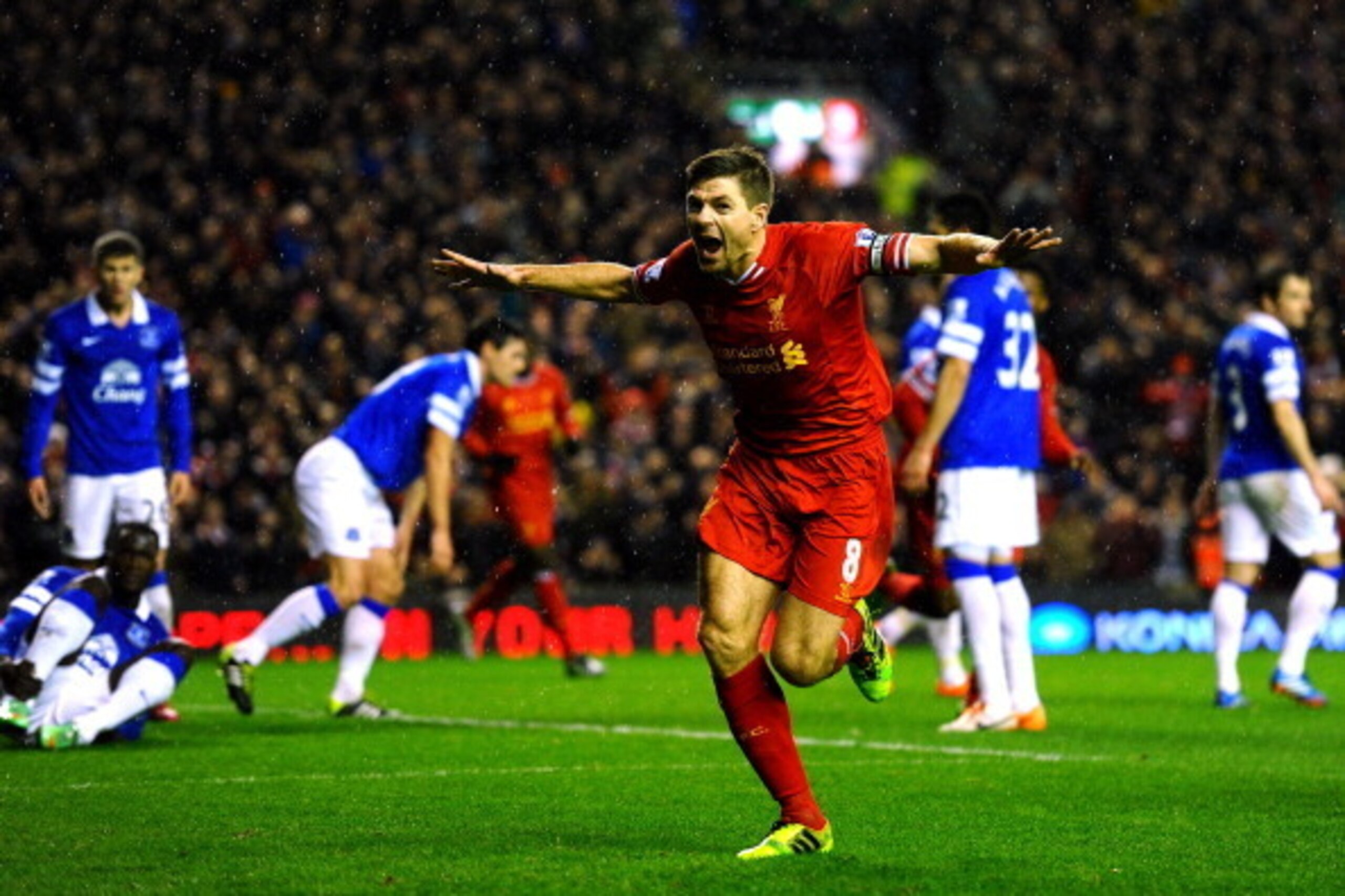 LIVERPOOL, ENGLAND - JANUARY 28:  Steven Gerrard of Liverpool celebrates after scoring the opening goal during the Barclays Premier League match between Liverpool and Everton at Anfield on January 28, 2014 in Liverpool, England.  (Photo by Laurence Griffi