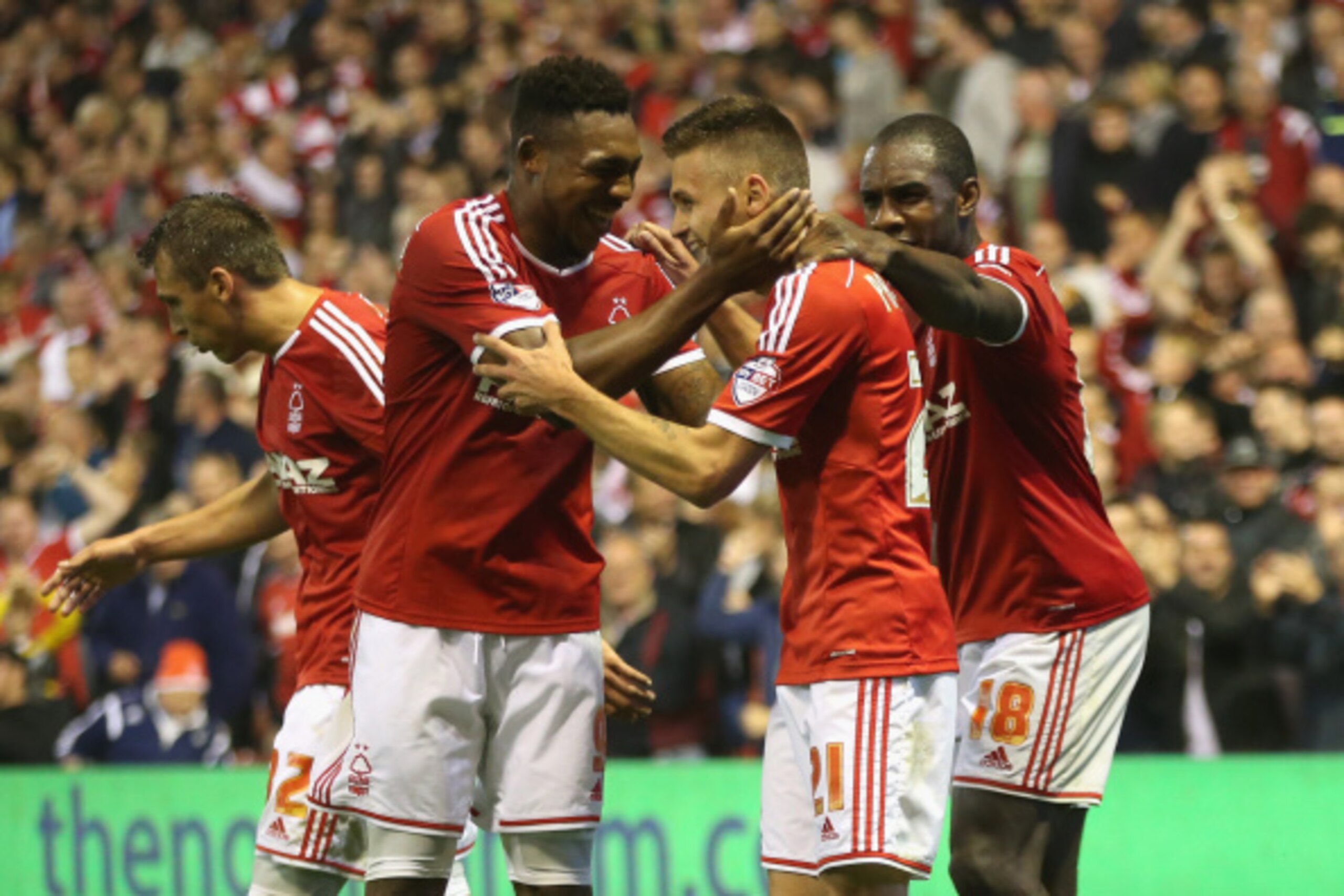 NOTTINGHAM, ENGLAND - SEPTEMBER 17:  Jamie Paterson of Nottingham Forest celebrates with team mates Britt Assombalonga (L) and Michail Antonio after scoring their fifth goal during the Sky Bet Championship match between Nottingham Forest and Fulham at the