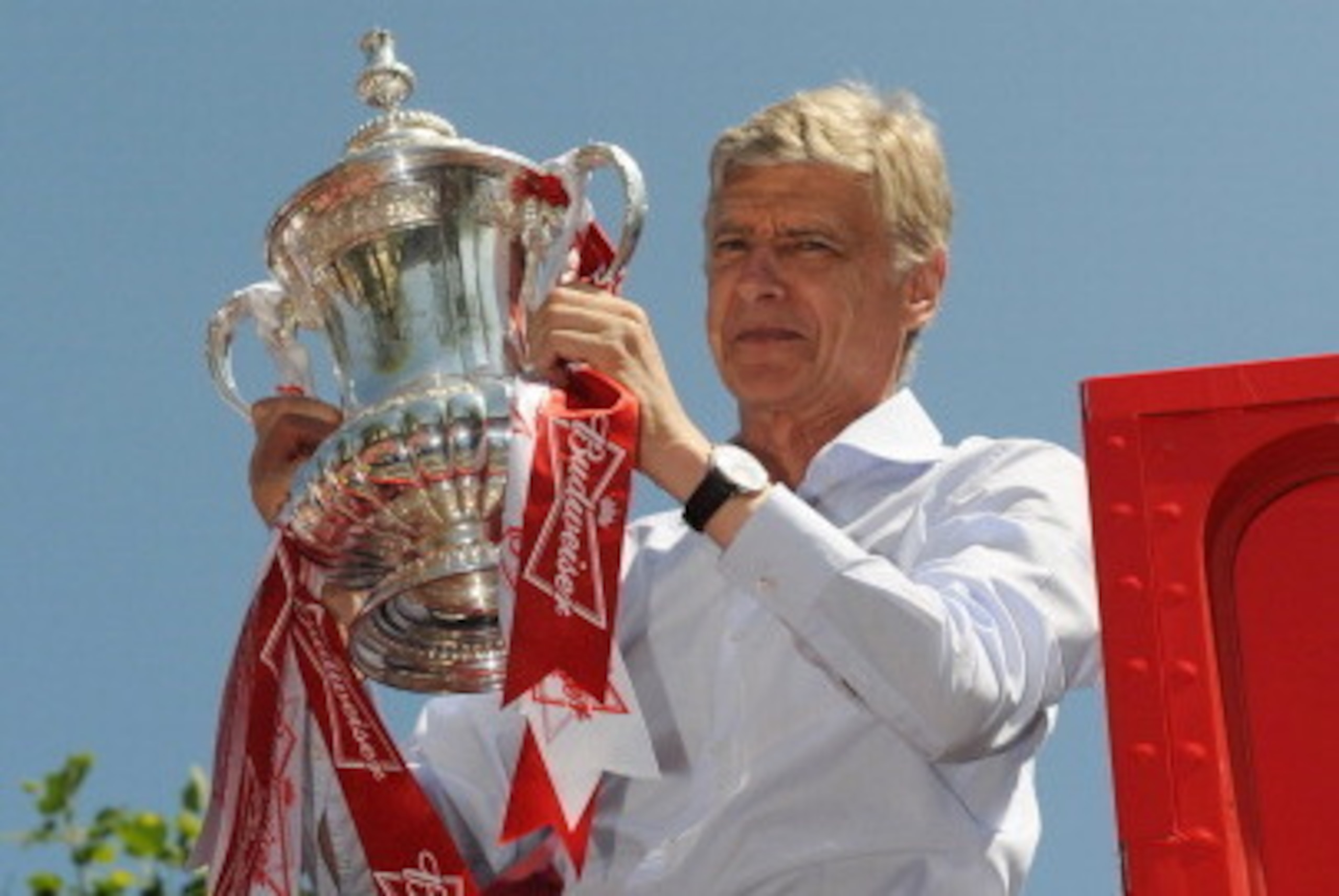 LONDON, ENGLAND - MAY 18: Arsene Wenger the manager of Arsenal FC celebrates with the FA Cup onboard the Arsenal team bus during the Arsenal FA Cup Victory Parade in Islington, London on May 18, 2014 in London, England. (Photo by Steve Bardens/Getty Image