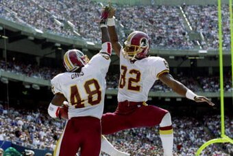 19 Sep 1999:  Stephen Davis #48 of the Washington Redskins celebrates with teammate Michael Westbrook #82 in the end zone during the game against the New York Giants at Giants Stadium in East Rutherford, New Jersey. The Redskins defeated the Giants 50-21.