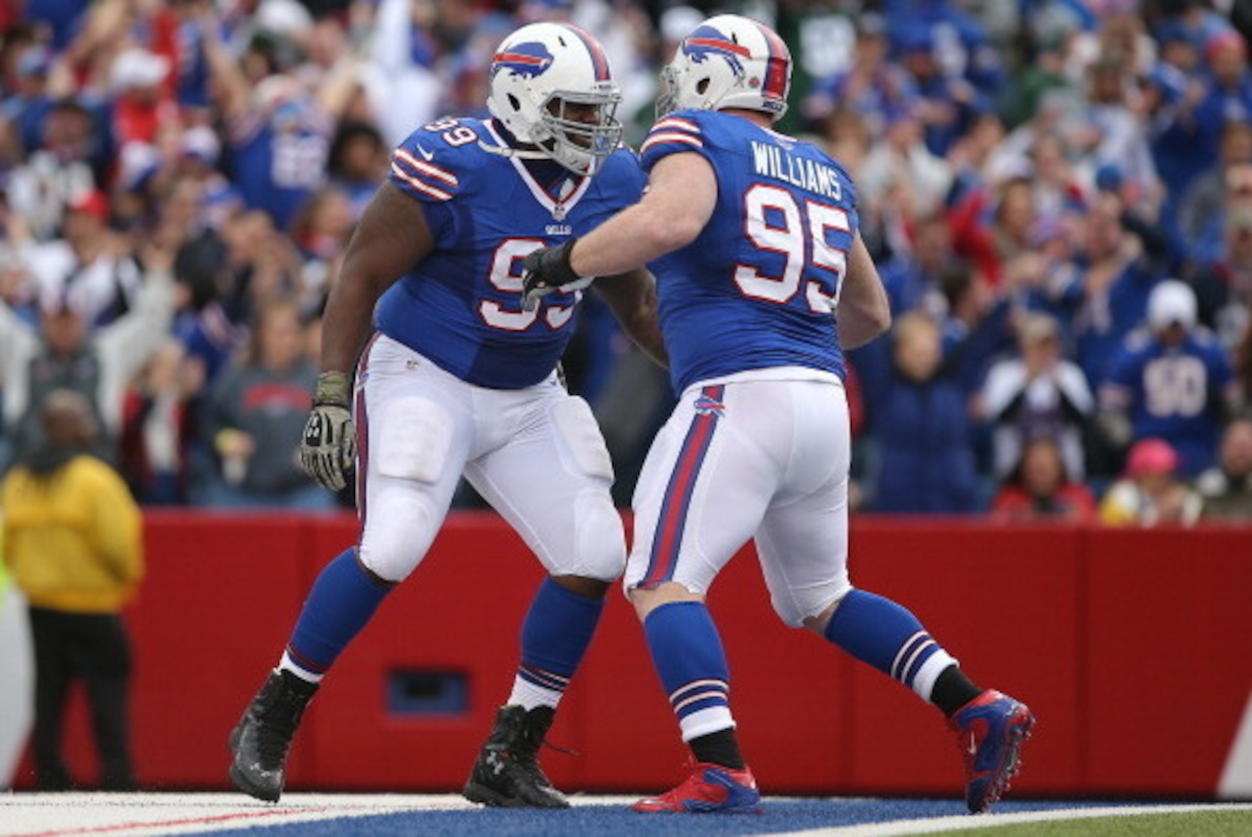 ORCHARD PARK, NY - NOVEMBER 17: Marcell Dareus #99 of the Buffalo Bills celebrates with Kyle Williams #95 after Williams forced a turnover during NFL game action against the New York Jets at Ralph Wilson Stadium on November 17, 2013 in Orchard Park, New Y