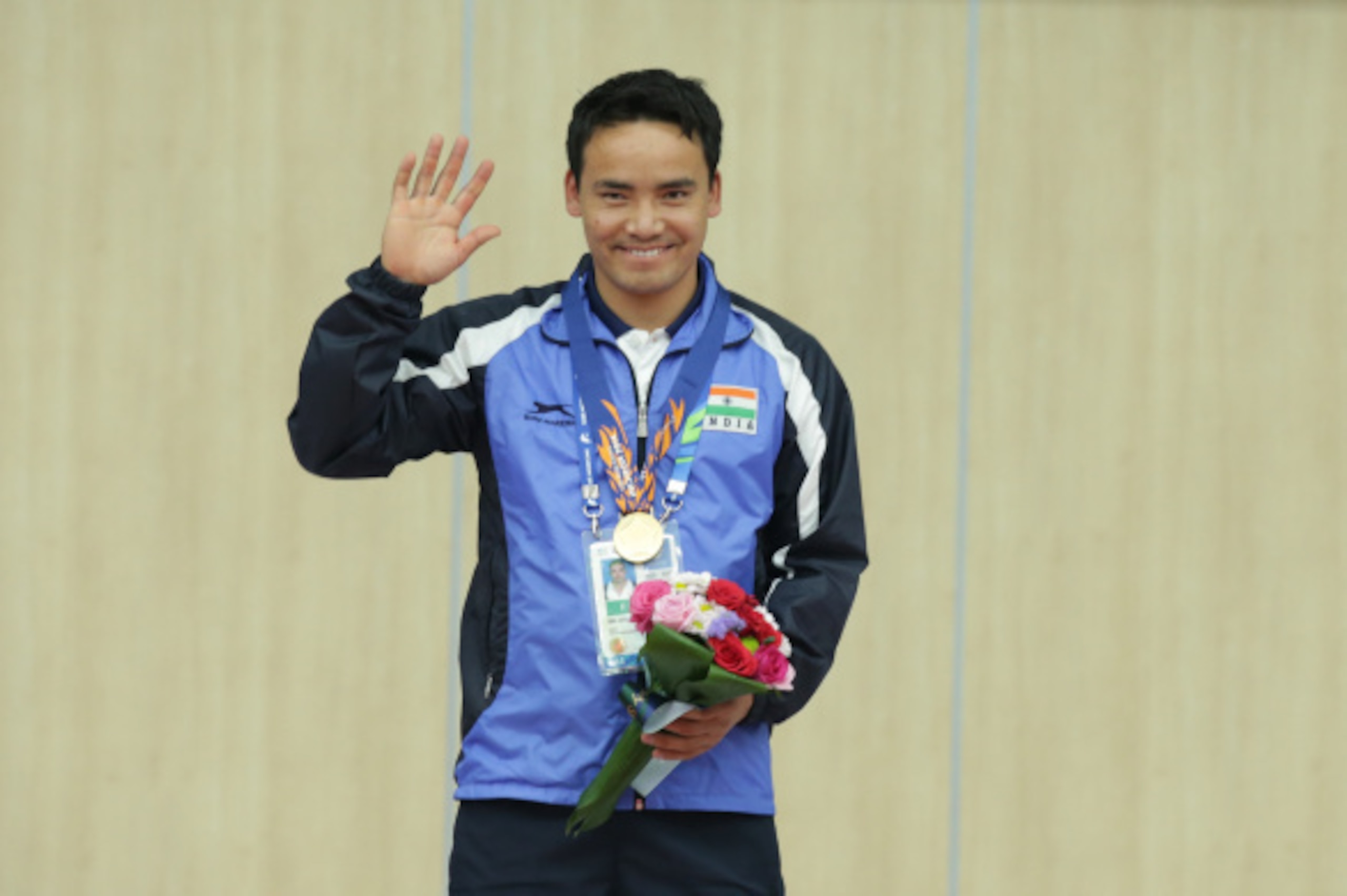 INCHEON, SOUTH KOREA - SEPTEMBER 20: Gold Medalist Rai Jitu of India celebrates on the podium after winning his gold medal in the 50m Pistol Men's event at Ongnyeon International Shooting Range during the 2014 Asian Games at on September 20, 2014 in Inche