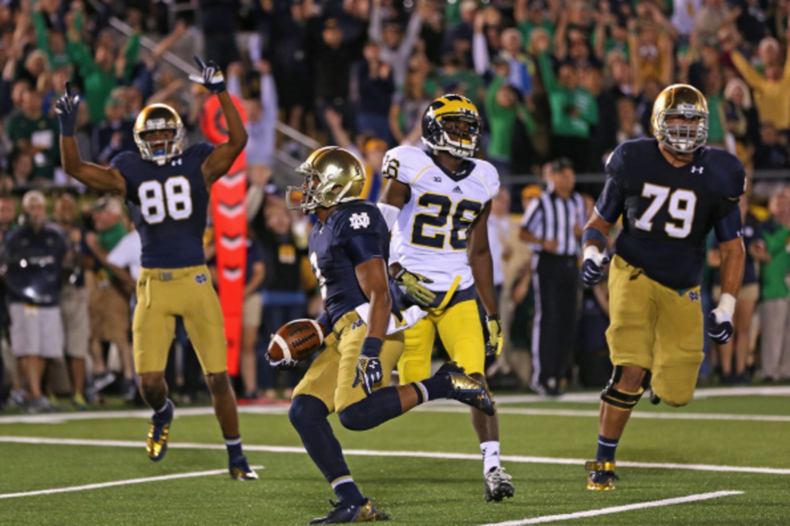 SOUTH BEND, IN - SEPTEMBER 06: Amir Carlisle #3 of the Notre Dame Fighting Irish scores a touchdown past teammates Steve Elmer #79 and Corey Robinson #88 and Jourdan Lewis #26 of the Michigan Wolverines at Notre Dame Stadium on September 6, 2014 in South 