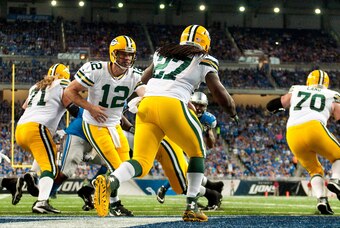 Sep 21, 2014; Detroit, MI, USA; Green Bay Packers quarterback Aaron Rodgers (12) hands off to running back Eddie Lacy (27) during the second quarter against the Detroit Lions at Ford Field. Mandatory Credit: Tim Fuller-USA TODAY Sports