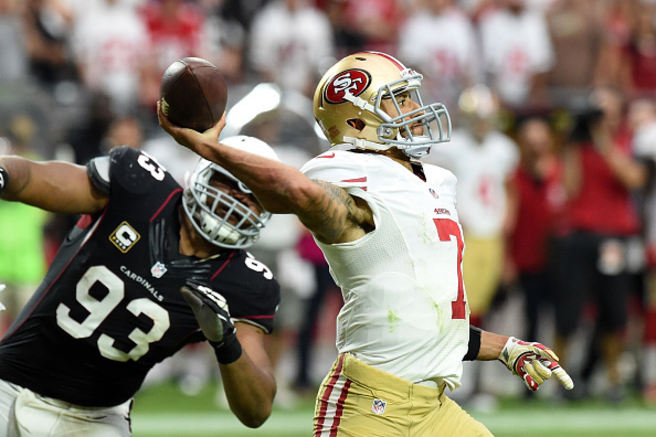 GLENDALE, AZ - SEPTEMBER 21: Quarterback Colin Kaepernick #7 of the San Francisco 49ers passes under pressure from Calais Campbell #93 of the Arizona Cardinals during the second half of the NFL game at the University of Phoenix Stadium on September 21, 20