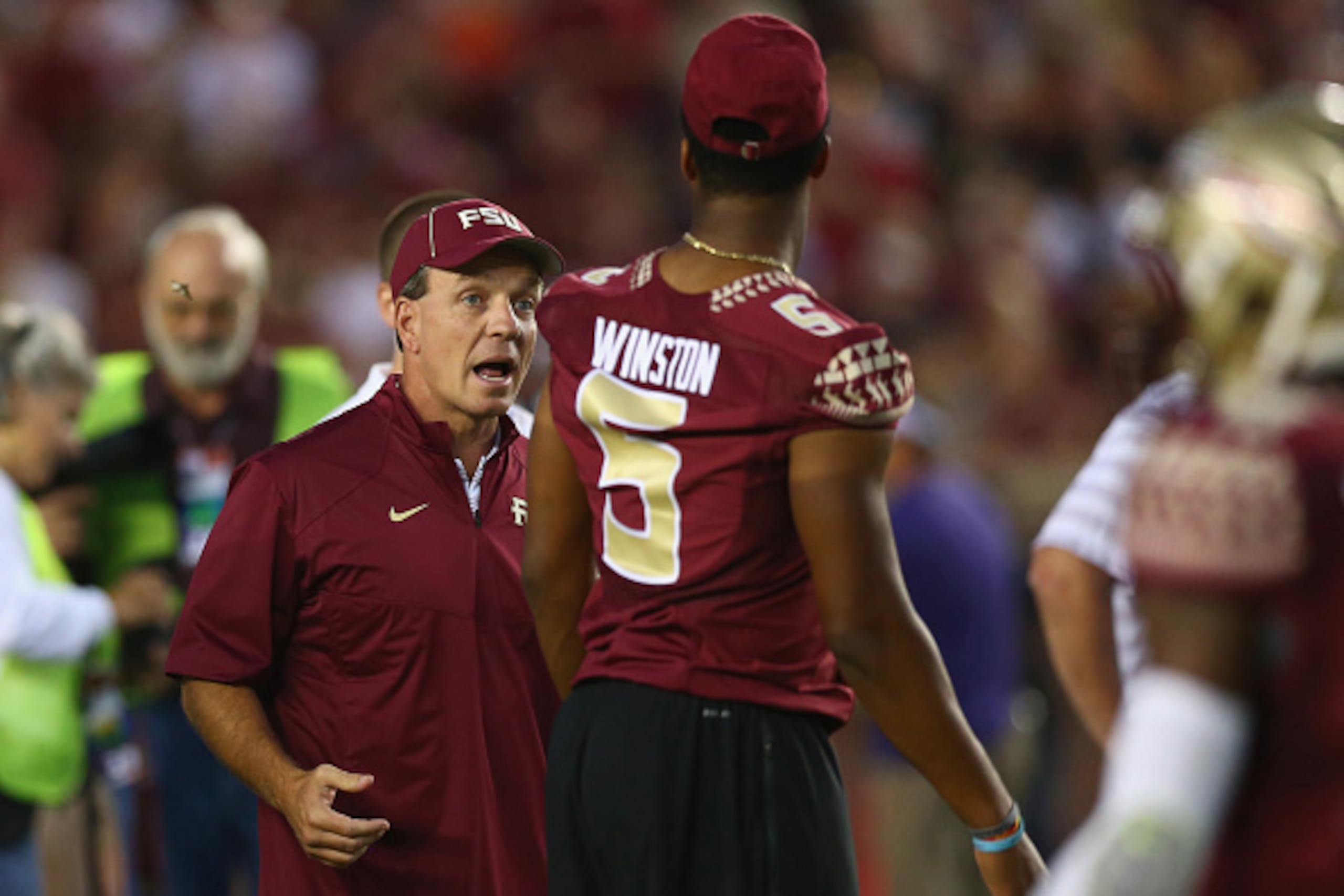 TALLAHASSEE, FL - SEPTEMBER 20:  Head coach Jimbo Fisher talks with Jameis Winston #5 of the Florida State Seminoles on the field during pregame against the Clemson Tigers at Doak Campbell Stadium on September 20, 2014 in Tallahassee, Florida.  (Photo by 