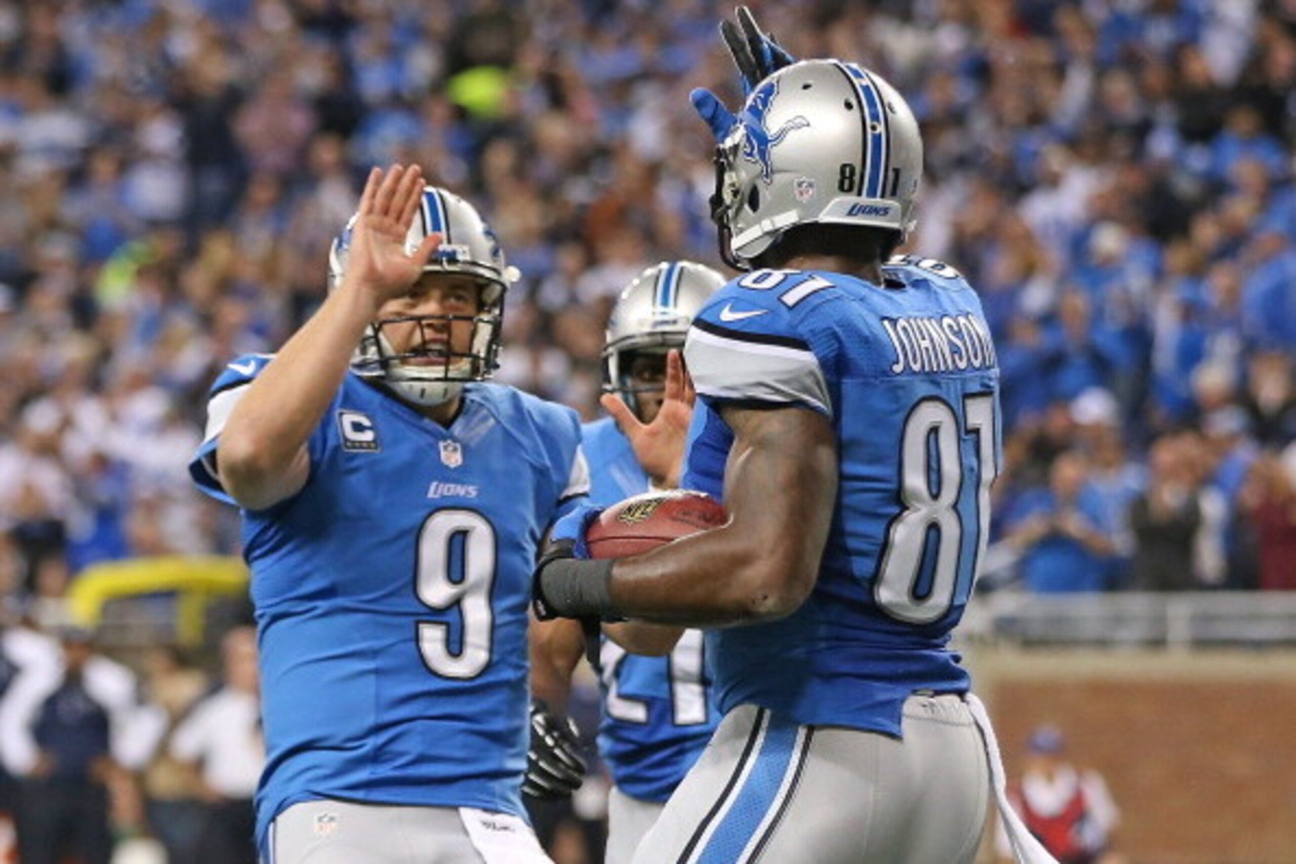 DETROIT, MI - OCTOBER 27: Matthew Stafford #9 of the Detroit Lions celebrates with teammate Calvin Johnson #81 after a first quarter touchdown the game against the Dallas Cowboys at Ford Field on October 27, 2013 in Detroit, Michigan.  (Photo by Leon Hali