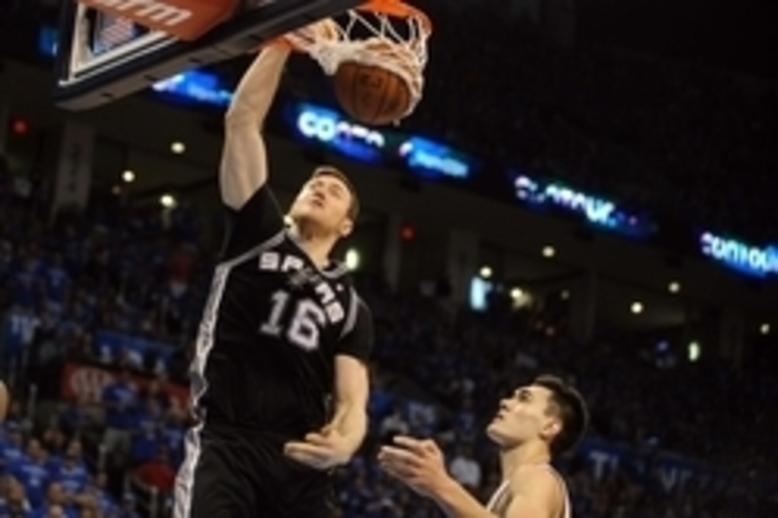 May 25, 2014; Oklahoma City, OK, USA; San Antonio Spurs forward Aron Baynes (16) dunks the ball against Oklahoma City Thunder center Steven Adams (12) during the fourth quarter in game three of the Western Conference Finals of the 2014 NBA Playoffs at Che May 25, 2014; Oklahoma City, OK, USA; San Antonio Spurs forward Aron Baynes (16) dunks the ball against Oklahoma City Thunder center Steven Adams (12) during the fourth quarter in game three of the Western Conference Finals of the 2014 NBA Playoffs at Che