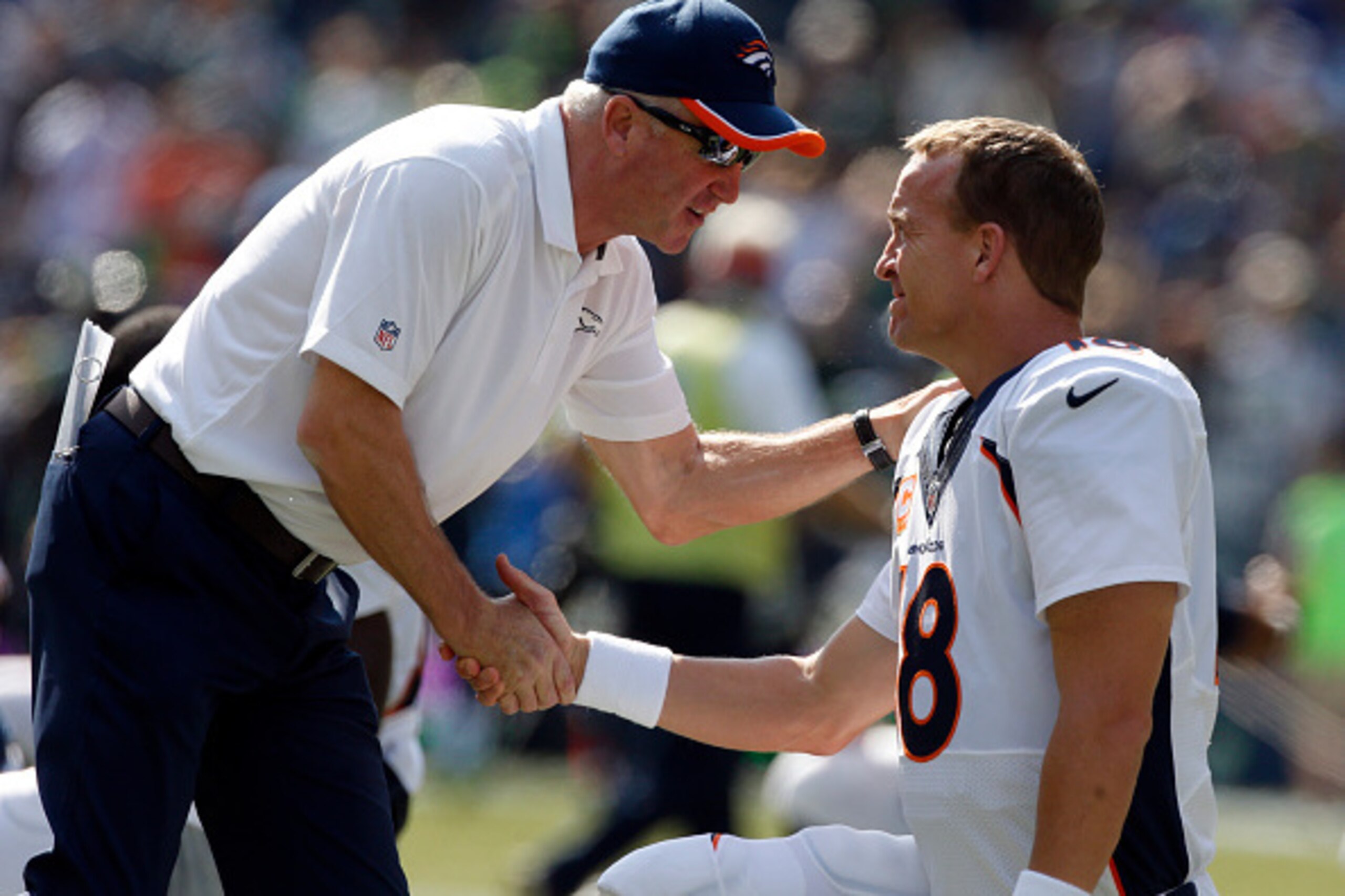 SEATTLE, WA - SEPTEMBER 21: Head coach John Fox of the Denver Broncos greets quarterback Peyton Manning #18 of the Denver Broncos as he warms up before the game against the Seattle Seahawks at CenturyLink Field on September 21, 2014 in Seattle,Washington.