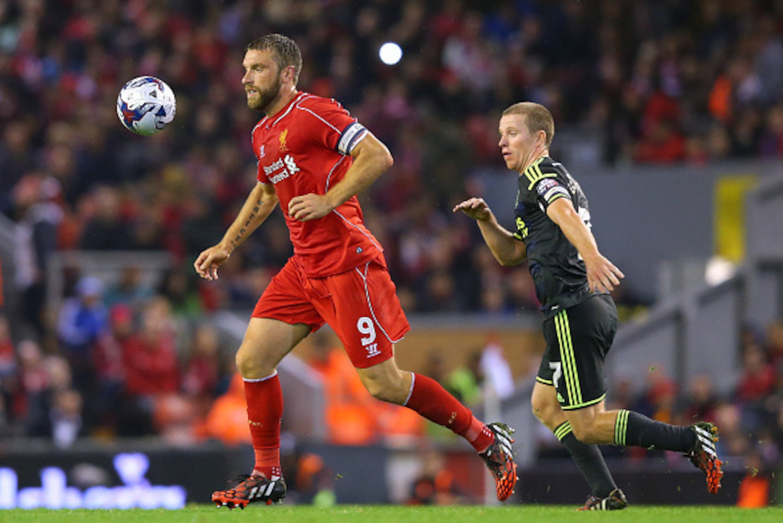 LIVERPOOL, ENGLAND - SEPTEMBER 23:  Rickie Lambert of Liverpool beats Grant Leadbitter of Middlesbrough during the Capital One Cup Third Round match between Liverpool and Middlesbrough at Anfield on September 23, 2014 in Liverpool, England.  (Photo by Ale