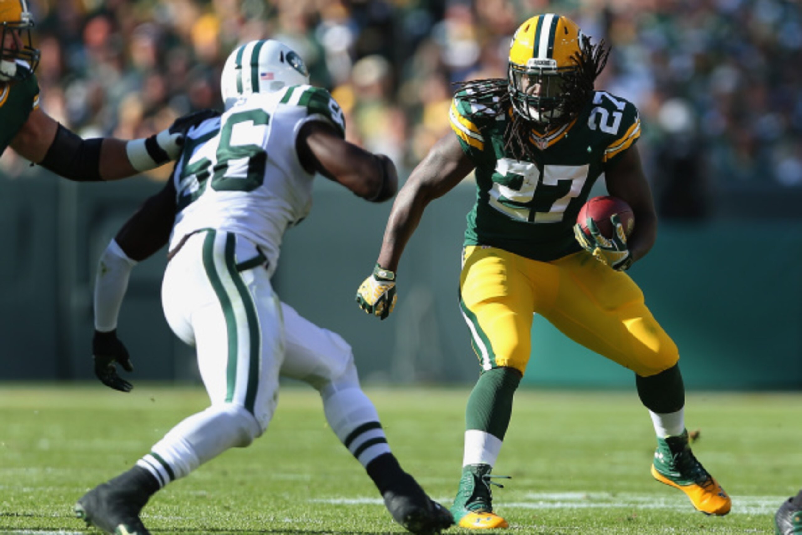 GREEN BAY, WI - SEPTEMBER 14:  Running back Eddie Lacy #27 of the Green Bay Packers rushes the football against the New York Jets during the NFL game at Lambeau Field on September 14, 2014 in Green Bay, Wisconsin. The Packers defeated the Jets 31-24.  (Ph