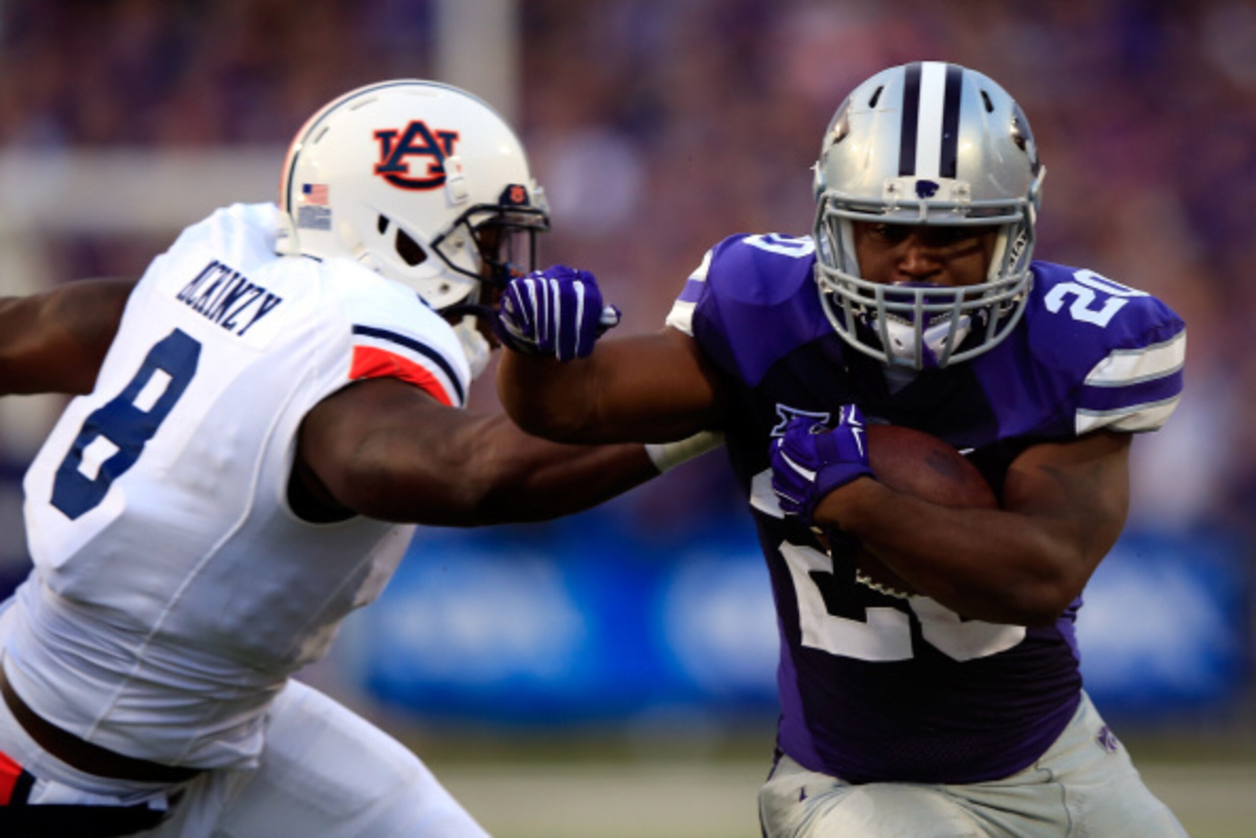 MANHATTAN, KS - SEPTEMBER 18: Running back DeMarcus Robinson #20 of the Kansas State Wildcats carries the ball as linebacker Cassanova McKinzy #8 of the Auburn Tigers defends during the game at Bill Snyder Family Football Stadium on September 18, 2014 in MANHATTAN, KS - SEPTEMBER 18: Running back DeMarcus Robinson #20 of the Kansas State Wildcats carries the ball as linebacker Cassanova McKinzy #8 of the Auburn Tigers defends during the game at Bill Snyder Family Football Stadium on September 18, 2014 in