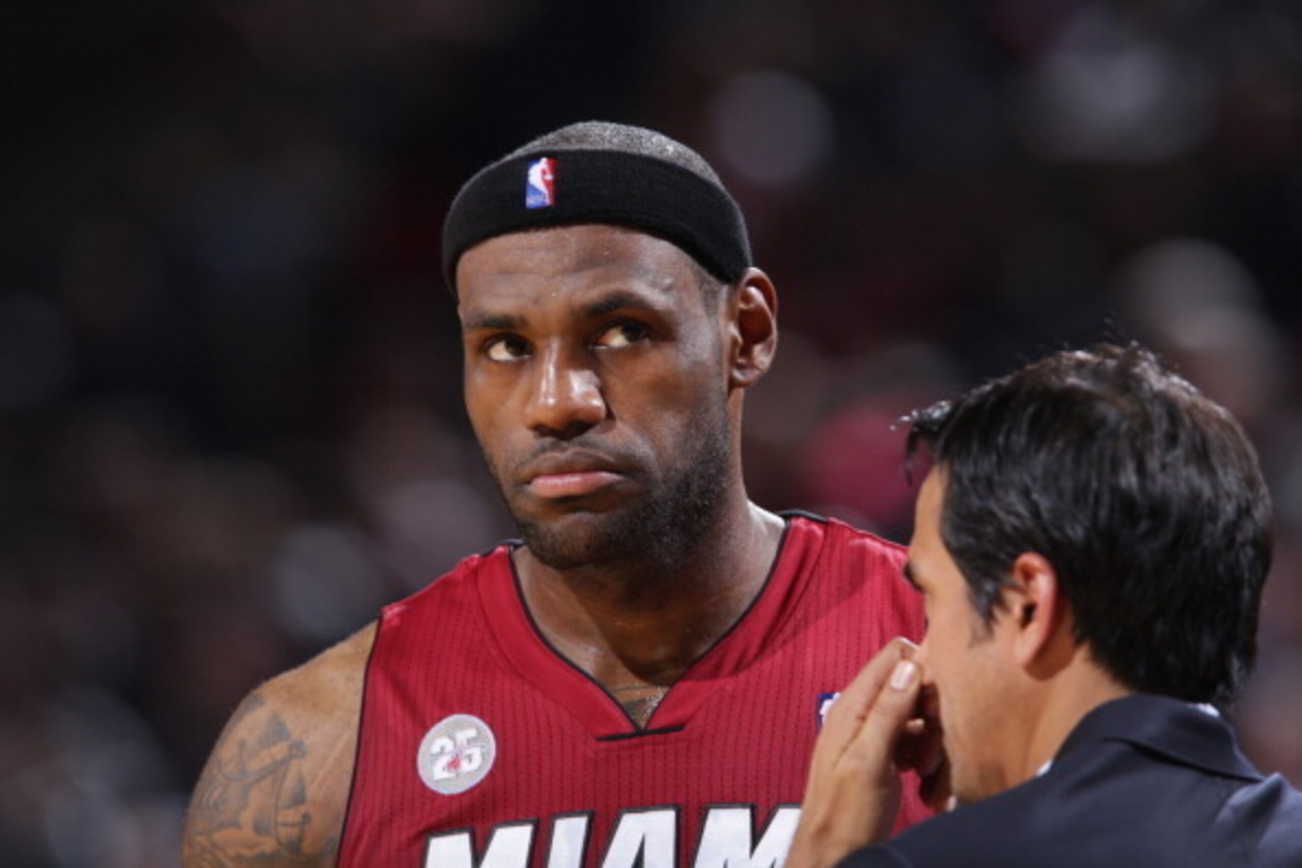 PORTLAND, OR - JANUARY 10:  LeBron James #6 and Erik Spoelstra of the Miami Heat dicuss a play against the Portland Trail Blazers on January 10, 2013 at the Rose Garden Arena in Portland, Oregon. NOTE TO USER: User expressly acknowledges and agrees that, 