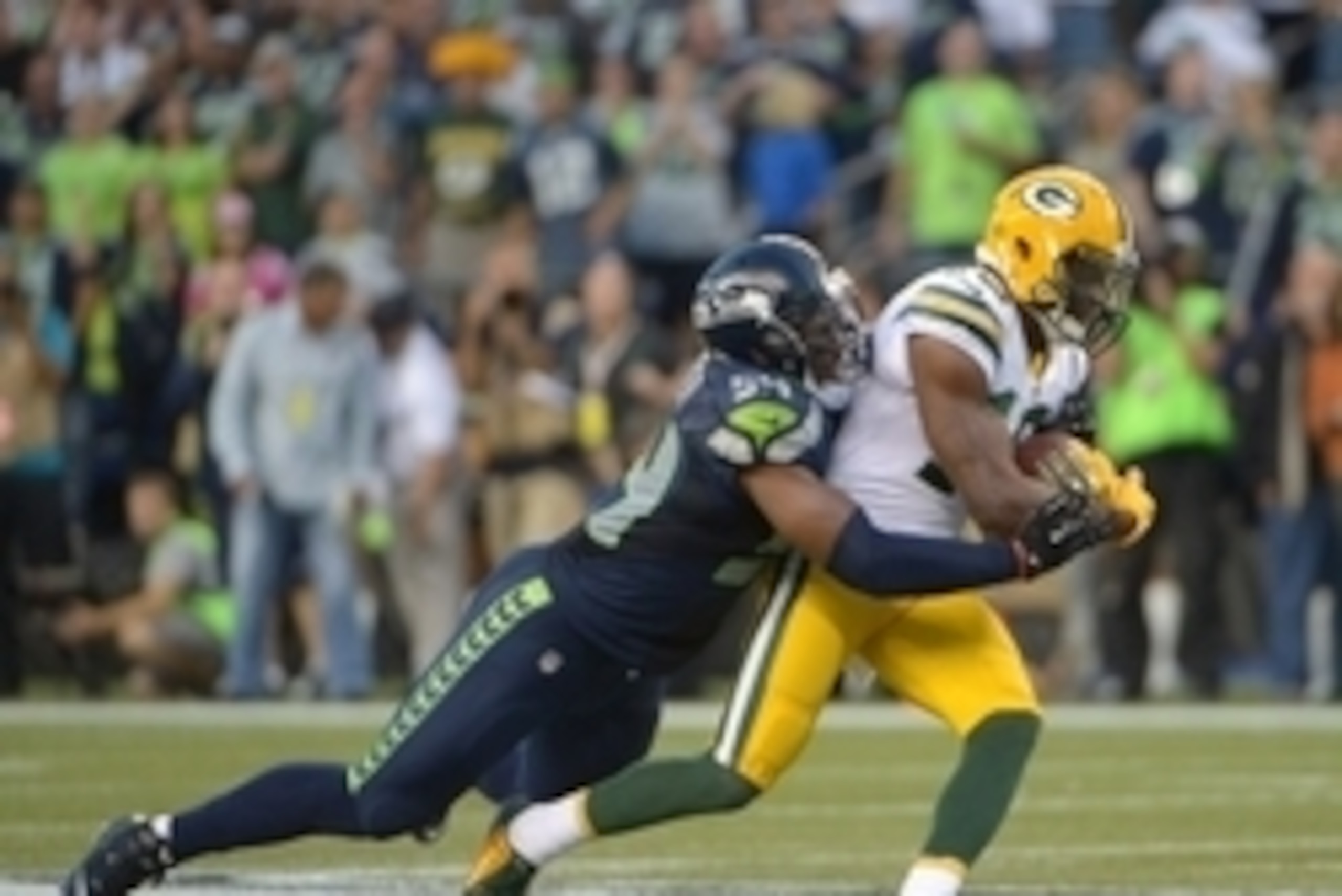Sep 4, 2014; Seattle, WA, USA; Seattle Seahawks linebacker Bobby Wagner (54) tackles Green Bay Packers receiver Randall Cobb (18) at CenturyLink Field. The Seahawks defeated the Packers 36-16. Mandatory Credit: Kirby Lee-USA TODAY Sports