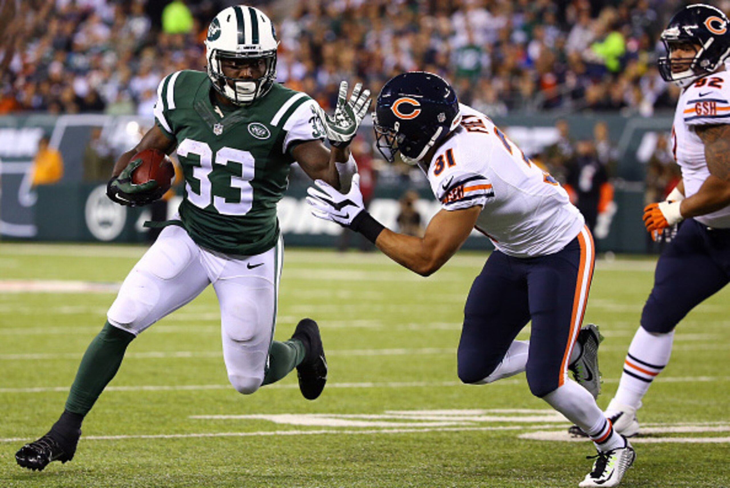 EAST RUTHERFORD, NJ - SEPTEMBER 22: Running back Chris Ivory #33 of the New York Jets carries the ball as cornerback Isaiah Frey #31 of the Chicago Bears defends during a game at MetLife Stadium on September 22, 2014 in East Rutherford, New Jersey.  (Phot