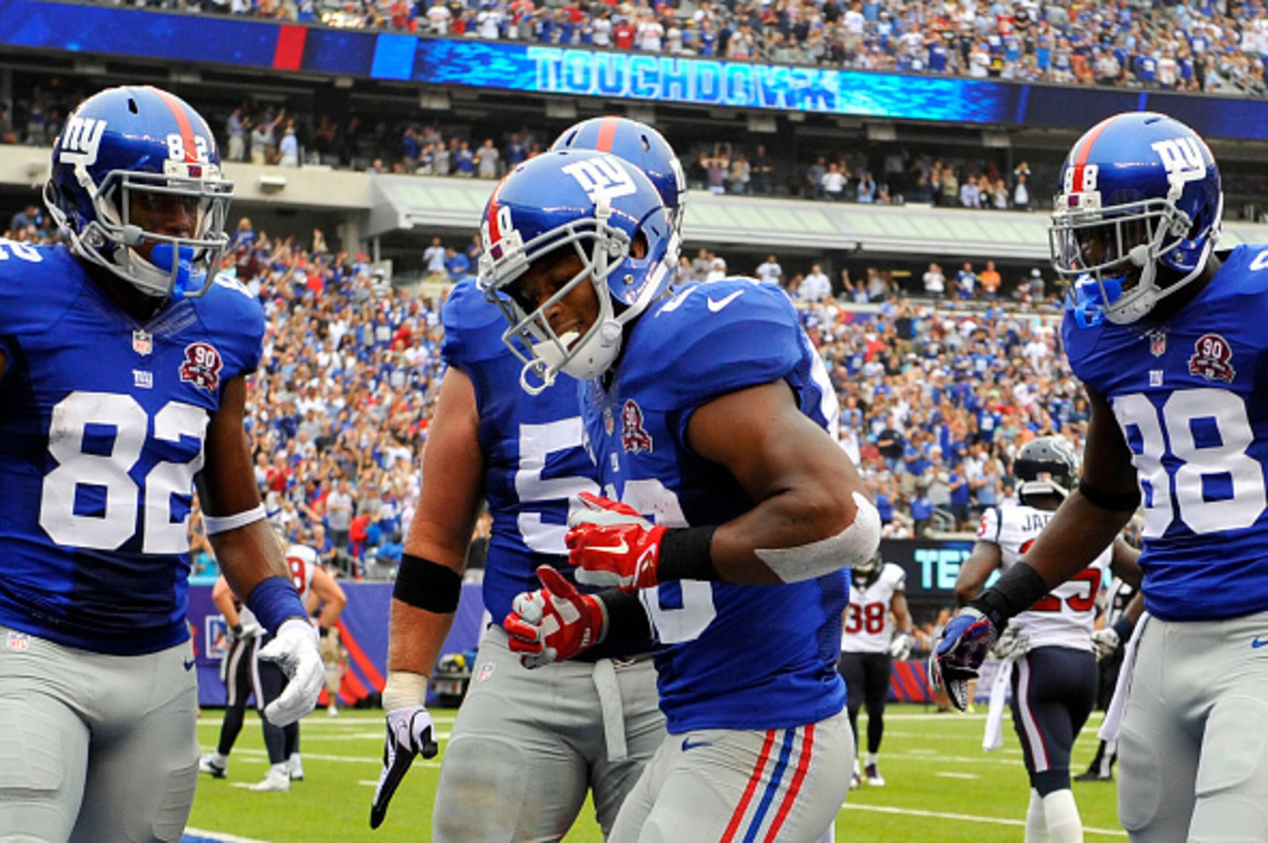 EAST RUTHERFORD, NJ - SEPTEMBER 21:  Victor Cruz #80 of the New York Giants celebrates his touchdown with a dance against the Houston Texans in the second quarter at MetLife Stadium on September 21, 2014 in East Rutherford, New Jersey.  (Photo by Alex Goo
