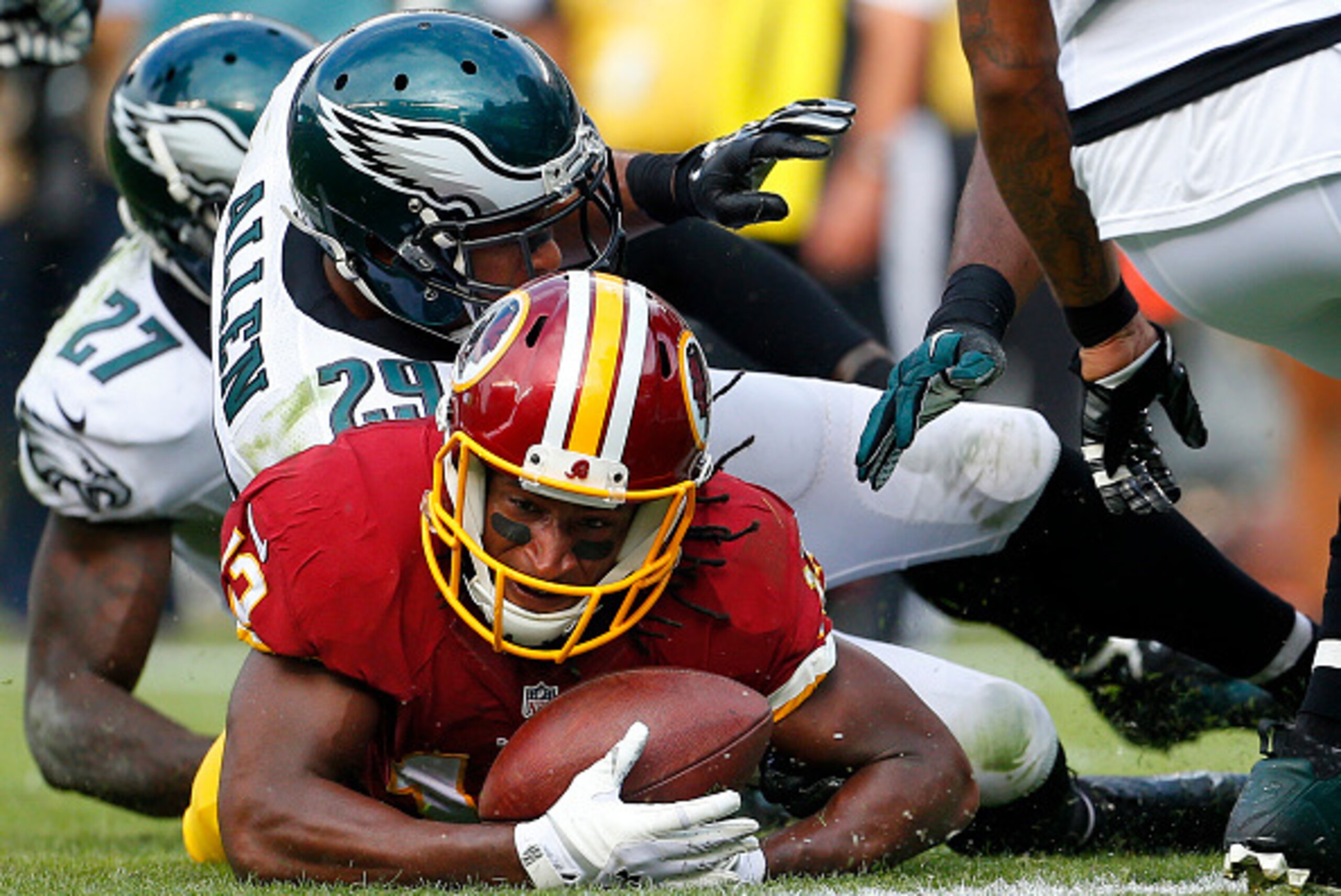 PHILADELPHIA, PA - SEPTEMBER 21:  Andre Roberts #12 of the Washington Redskins is tackled just before the goal line by Nate Allen #29 and Malcolm Jenkins #27 of the Philadelphia Eagles during the fourth quarter at Lincoln Financial Field on September 21, 