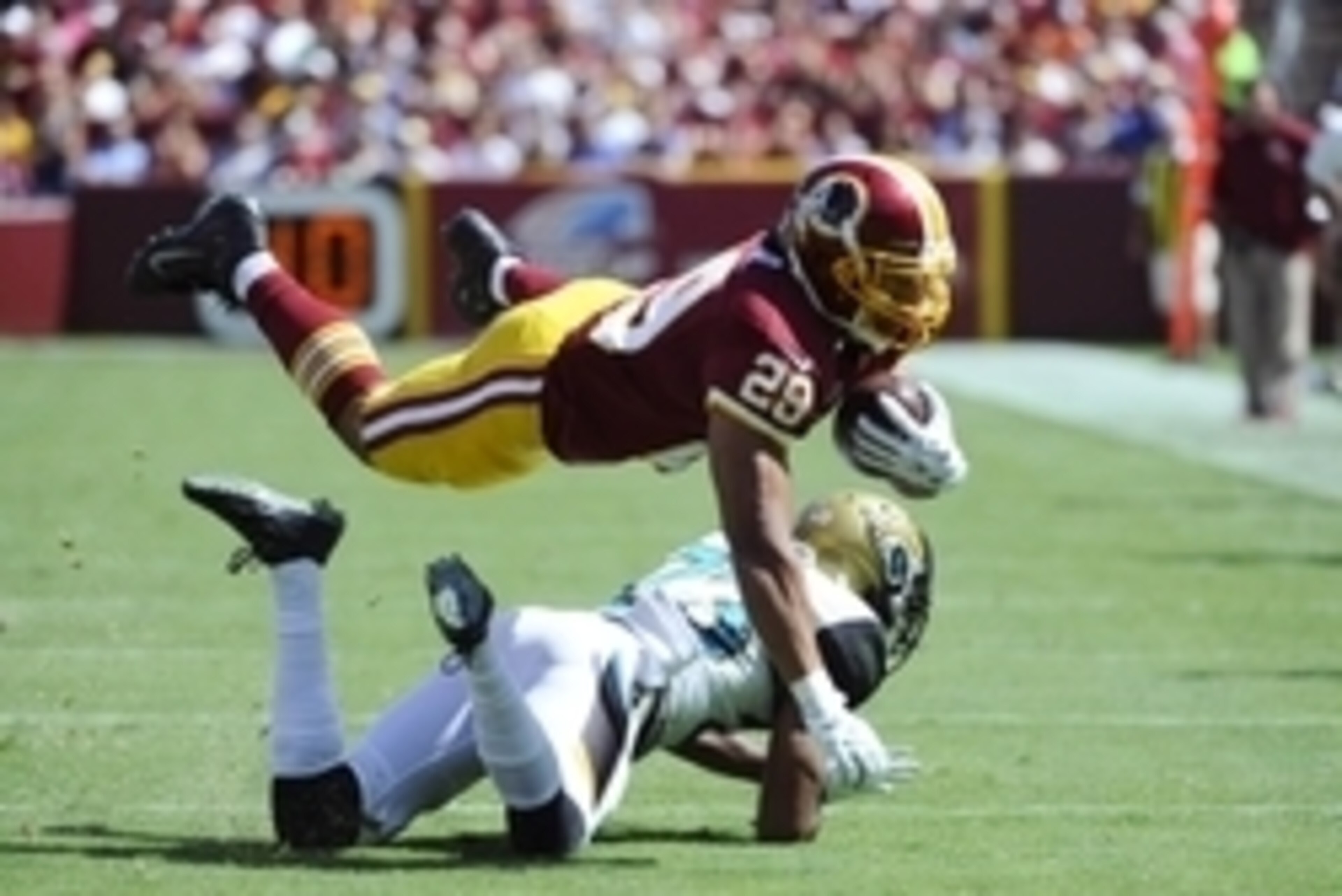 Sep 14, 2014; Landover, MD, USA; Washington Redskins running back Roy Helu (29) is tackled by Jacksonville Jaguars cornerback Alan Ball (23) during the first half at FedEx Field. Mandatory Credit: Brad Mills-USA TODAY Sports