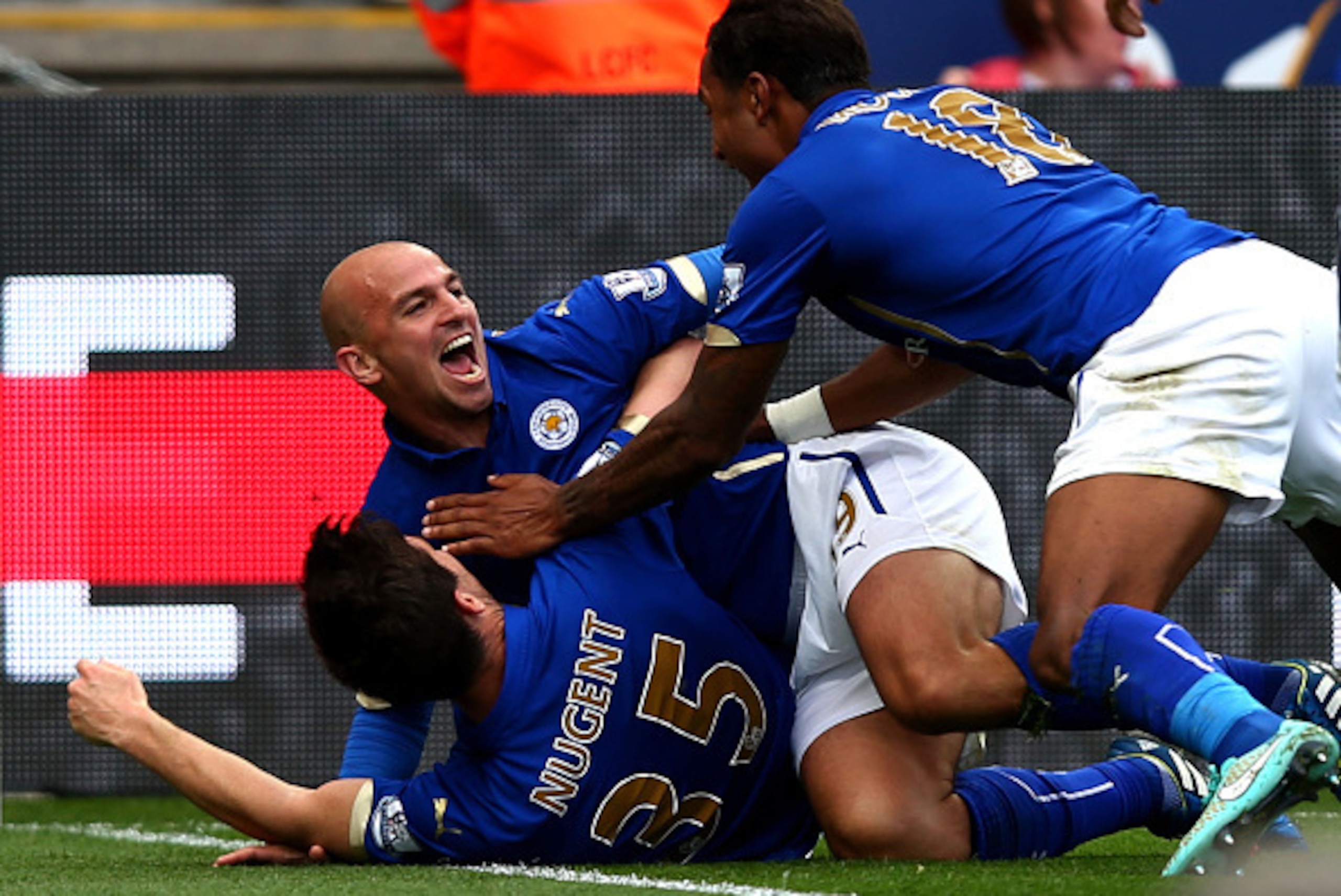 LEICESTER, ENGLAND - SEPTEMBER 21:  Esteban Cambiasso of Leicester City celebrates with David Nugent and Liam Moore of Leicester City after scoring his team's third goal during the Barclays Premier League match between Leicester City and Manchester United