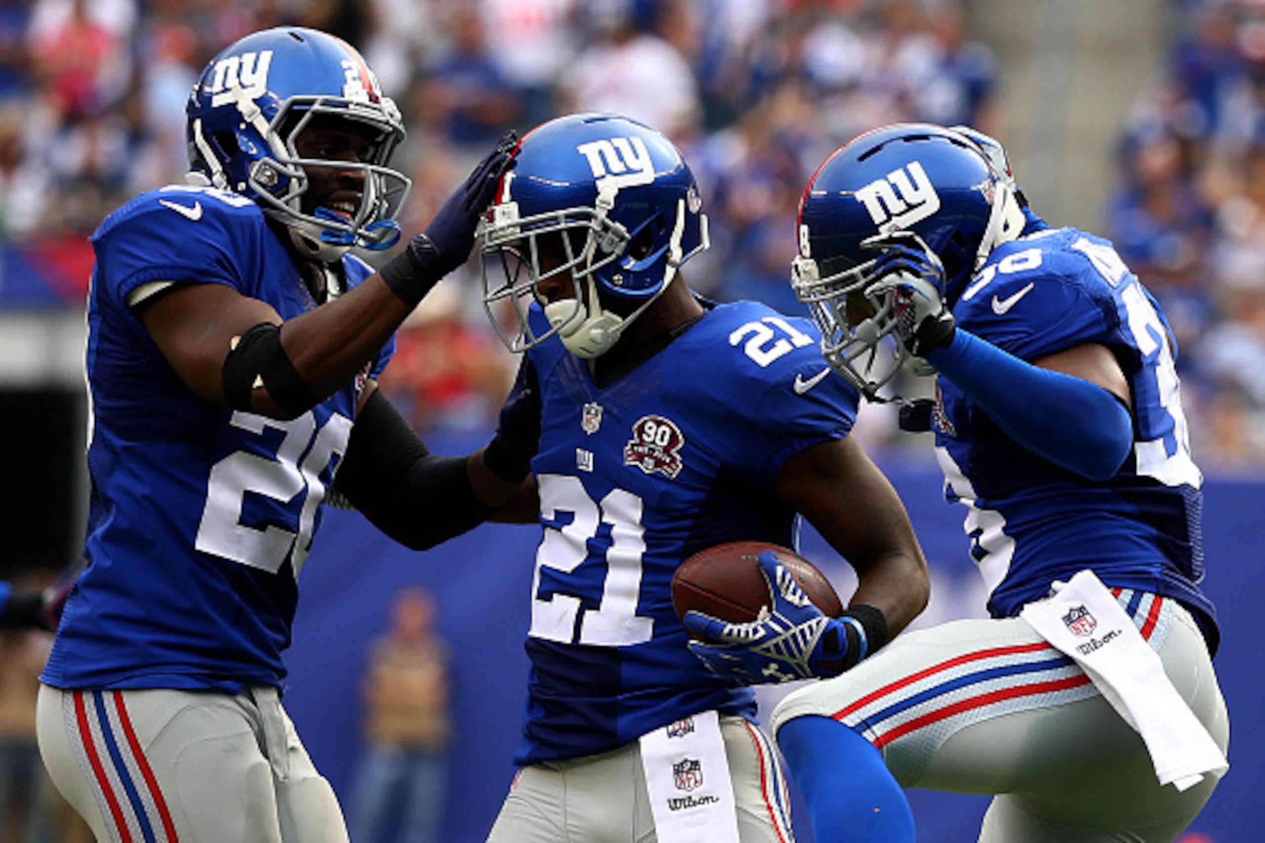 EAST RUTHERFORD, NJ - SEPTEMBER 21:  Dominique Rodgers-Cromartie #21 of the New York Giants celebrates his interception with teammates  Prince Amukamara #20 and  Trumaine McBride #38 in the fourth quarter against the Houston Texans at MetLife Stadium on S