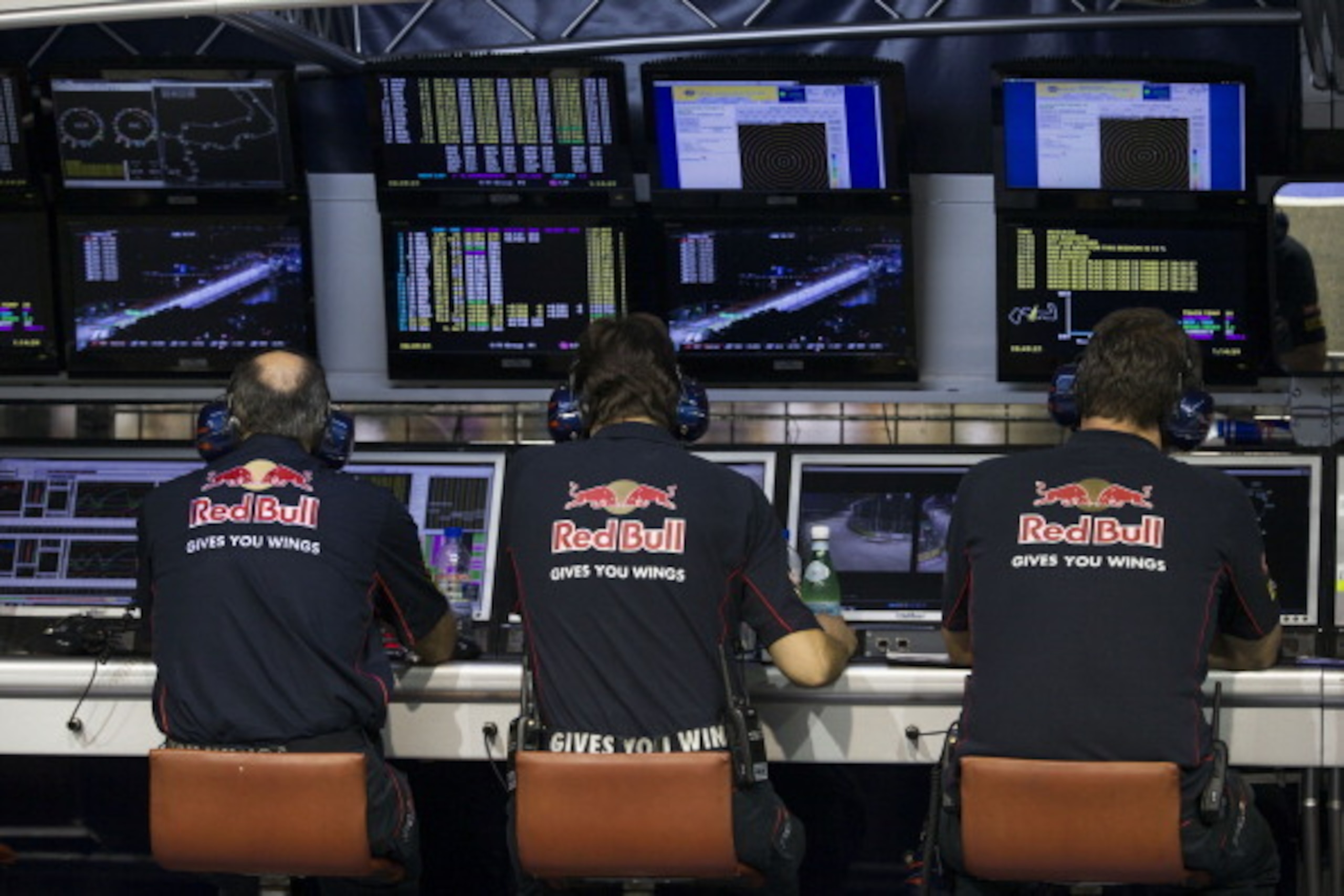 SINGAPORE - SEPTEMBER 22:  Scuderia Toro Rosso staff monitor their cars from the pit wall during the Singapore Formula One Grand Prix at Marina Bay Street Circuit on September 22, 2013 in Singapore, Singapore.  (Photo by Peter Fox/Getty Images)