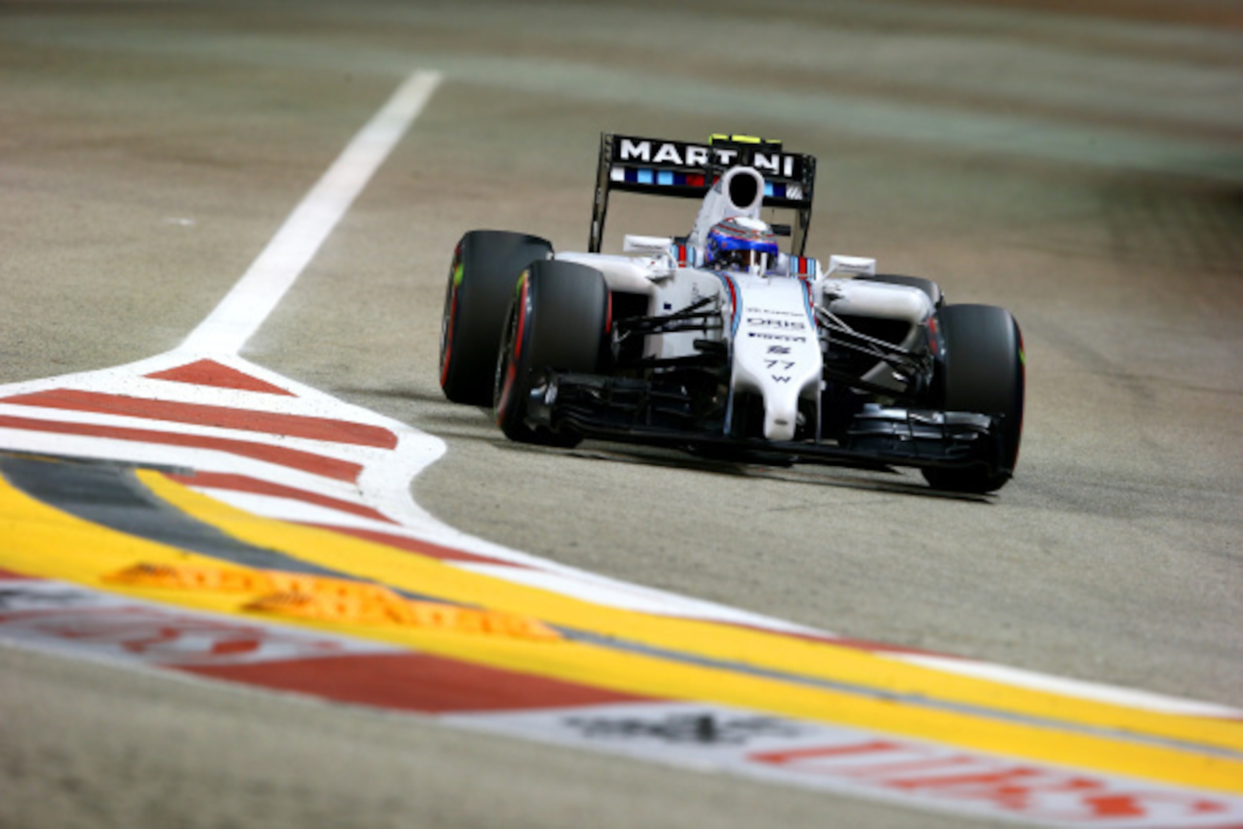 SINGAPORE - SEPTEMBER 20:  Valtteri Bottas of Finland and Williams drives during qualifying ahead of the Singapore Formula One Grand Prix at Marina Bay Street on September 20, 2014 in Singapore, Singapore.  (Photo by Mark Thompson/Getty Images)