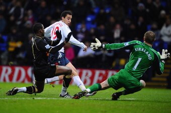 BOLTON, ENGLAND - JANUARY 05:  Rodrigo Moreno of Bolton Wanderers scores past Chris Kirkland of Wigan Athletic during the Barclays Premier League match between Bolton Wanderers and Wigan Athletic at Reebok Stadium on January 5, 2011 in Bolton, England.  (