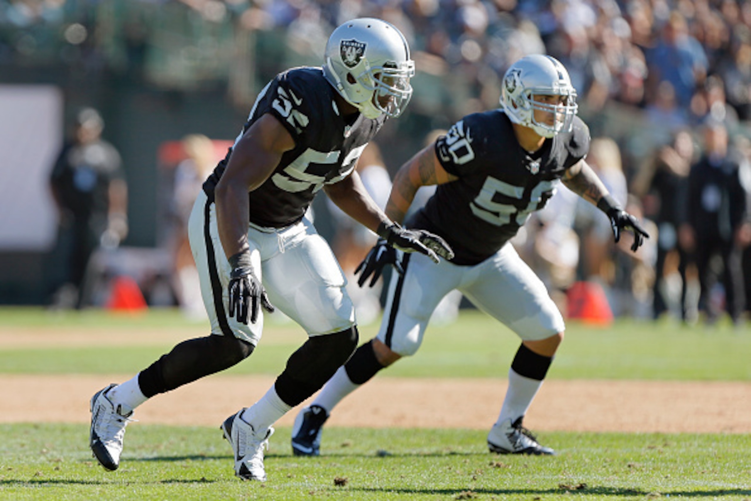 OAKLAND, CA - SEPTEMBER 14: Linebacker Khalil Mack #52 and Kaluka Maiava #50 of the Oakland Raiders defends against the Houston Texans in the fourth quarter on September 14, 2014 at O.co Coliseum in Oakland, California. The Texans won 30-14. (Photo by OAKLAND, CA - SEPTEMBER 14: Linebacker Khalil Mack #52 and Kaluka Maiava #50 of the Oakland Raiders defends against the Houston Texans in the fourth quarter on September 14, 2014 at O.co Coliseum in Oakland, California. The Texans won 30-14. (Photo by