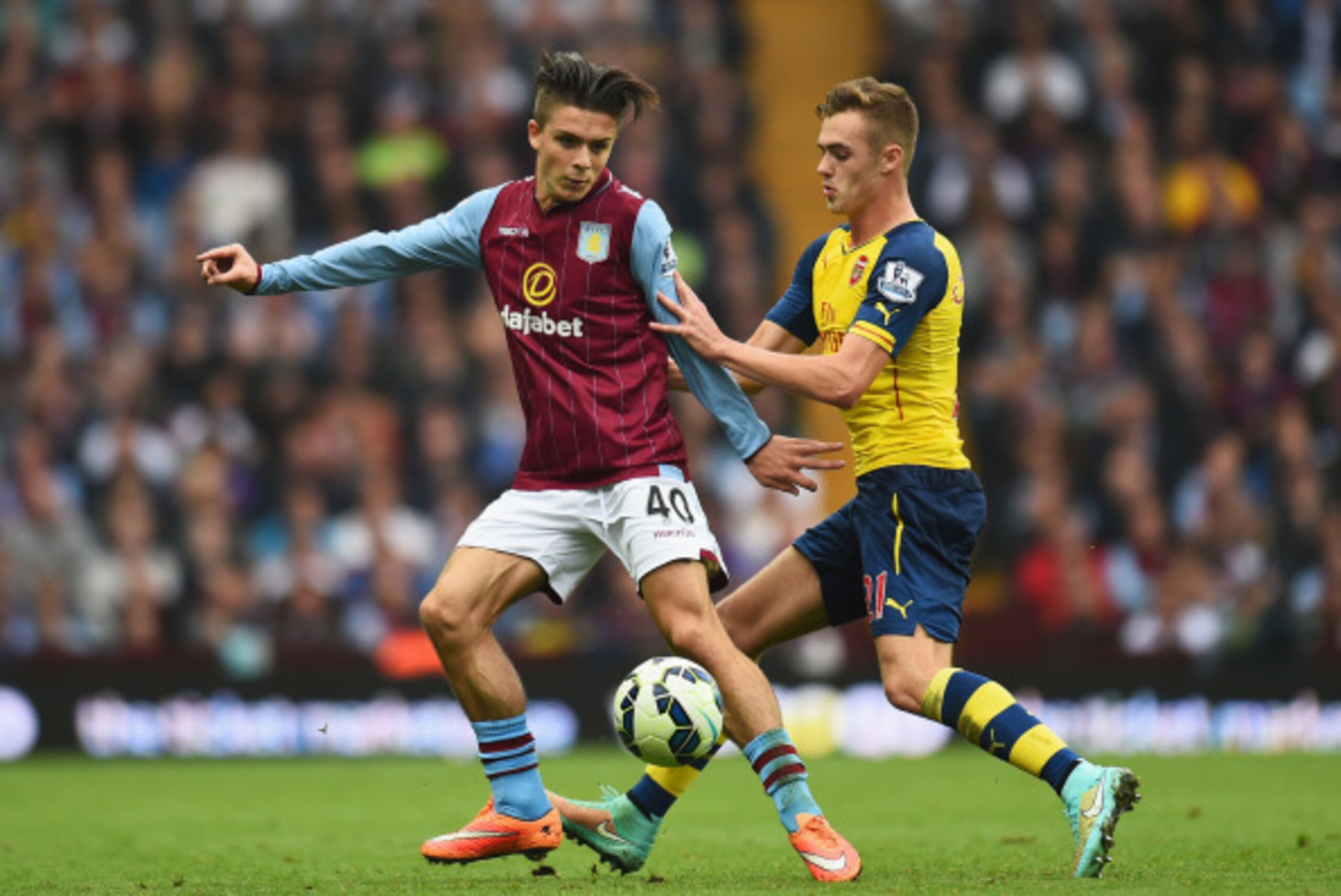BIRMINGHAM, ENGLAND - SEPTEMBER 20:  Jack Grealish of Aston Villa is closed down by Calum Chambers of Arsenal during the Barclays Premier League match between Aston Villa and Arsenal at Villa Park on September 20, 2014 in Birmingham, England.  (Photo by S