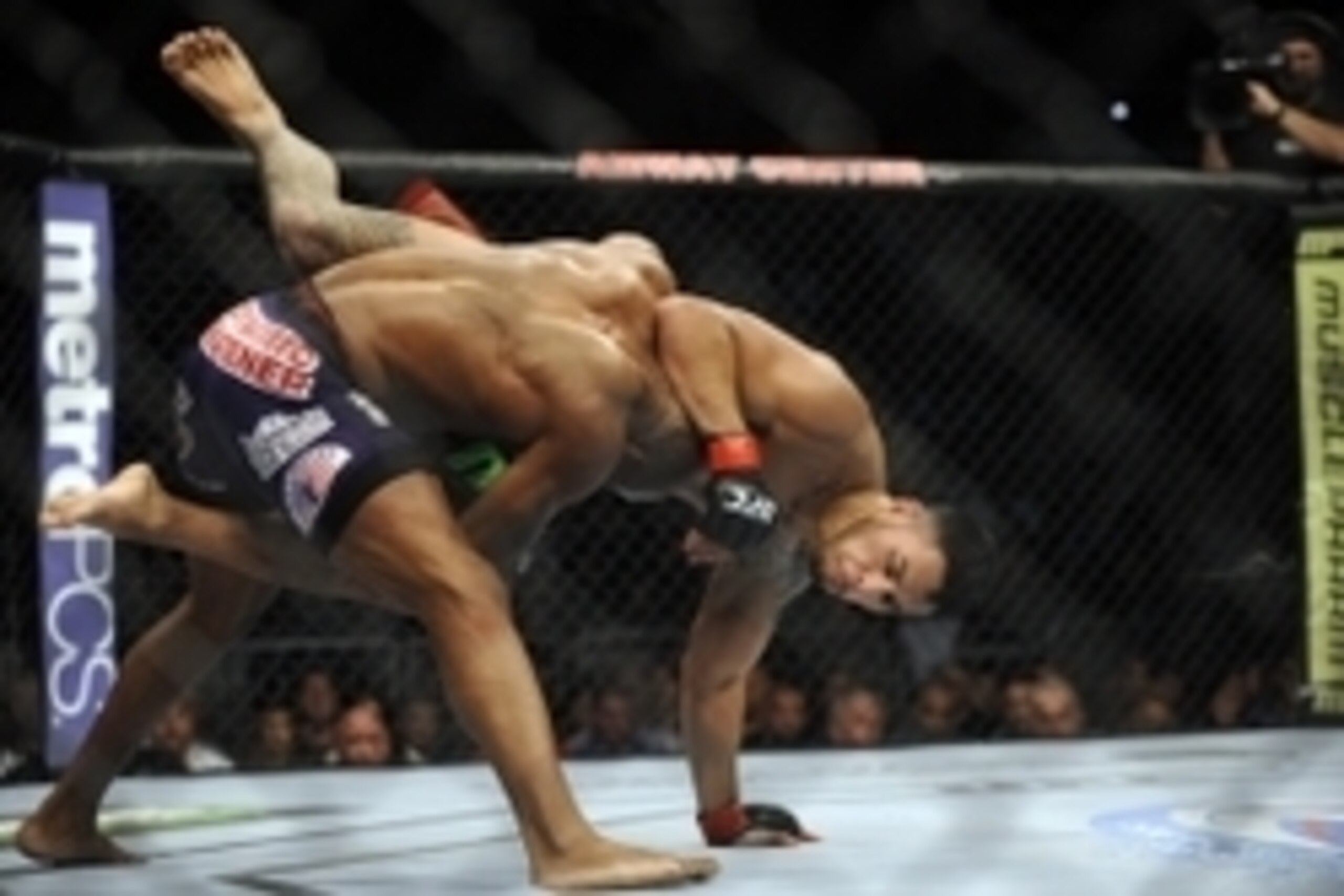 Apr 19, 2014; Orlando, FL, USA; Yoel Romero (blue gloves) picks up Brad Tavares (red gloves) in their middleweight fight during UFC on FOX 11 at Amway Center. Mandatory Credit: David Manning-USA TODAY Sports