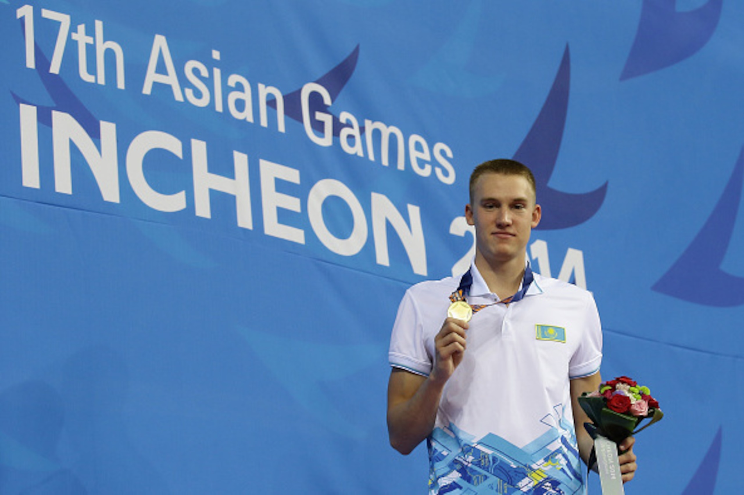 INCHEON, SOUTH KOREA - SEPTEMBER 24:  Gold medallist Dmitriy Balandin of Kazakhstan poses for a photo during the men's 100m breastroke final medal ceremony on day five of 2014 Asian Games at Munhak Park Tae-hwan Aquatics Center on September 23, 2014 in In
