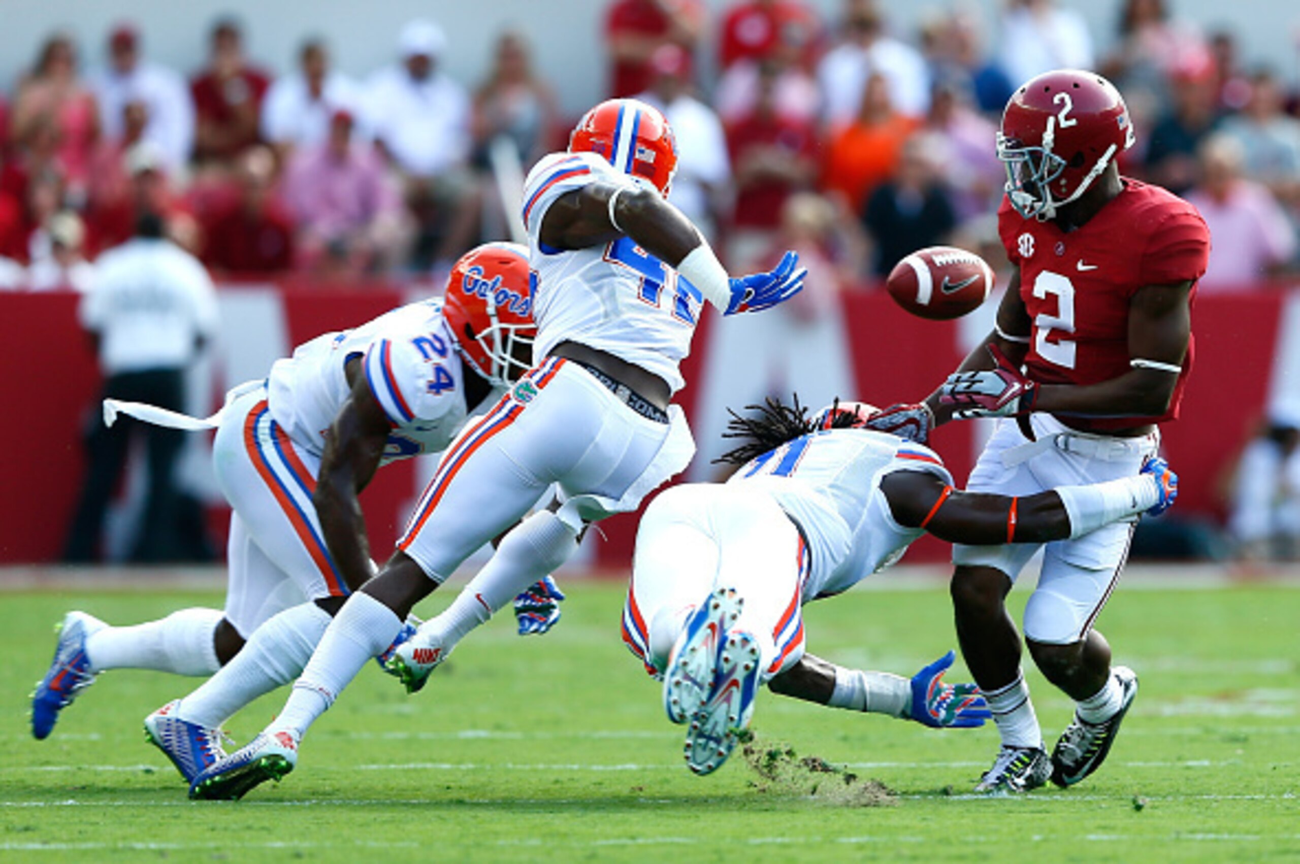 TUSCALOOSA, AL - SEPTEMBER 20:  Keanu Neal #42 and Neiron Ball #11 of the Florida Gators force a fumble by DeAndrew White #2 of the Alabama Crimson Tide at Bryant-Denny Stadium on September 20, 2014 in Tuscaloosa, Alabama.  Neal recovered the fumble for a