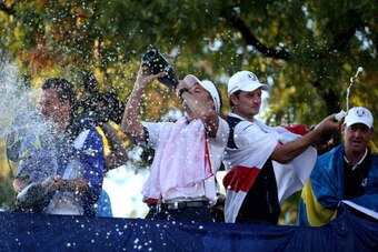 MEDINAH, IL - SEPTEMBER 30:  (L-R)  Ian Poulter, Justin Rose and Peter Hanson celebrate after Europe defeated the USA 14.5 to 13.5 to retain the Ryder Cup during the Singles Matches for The 39th Ryder Cup at Medinah Country Club on September 30, 2012 in M