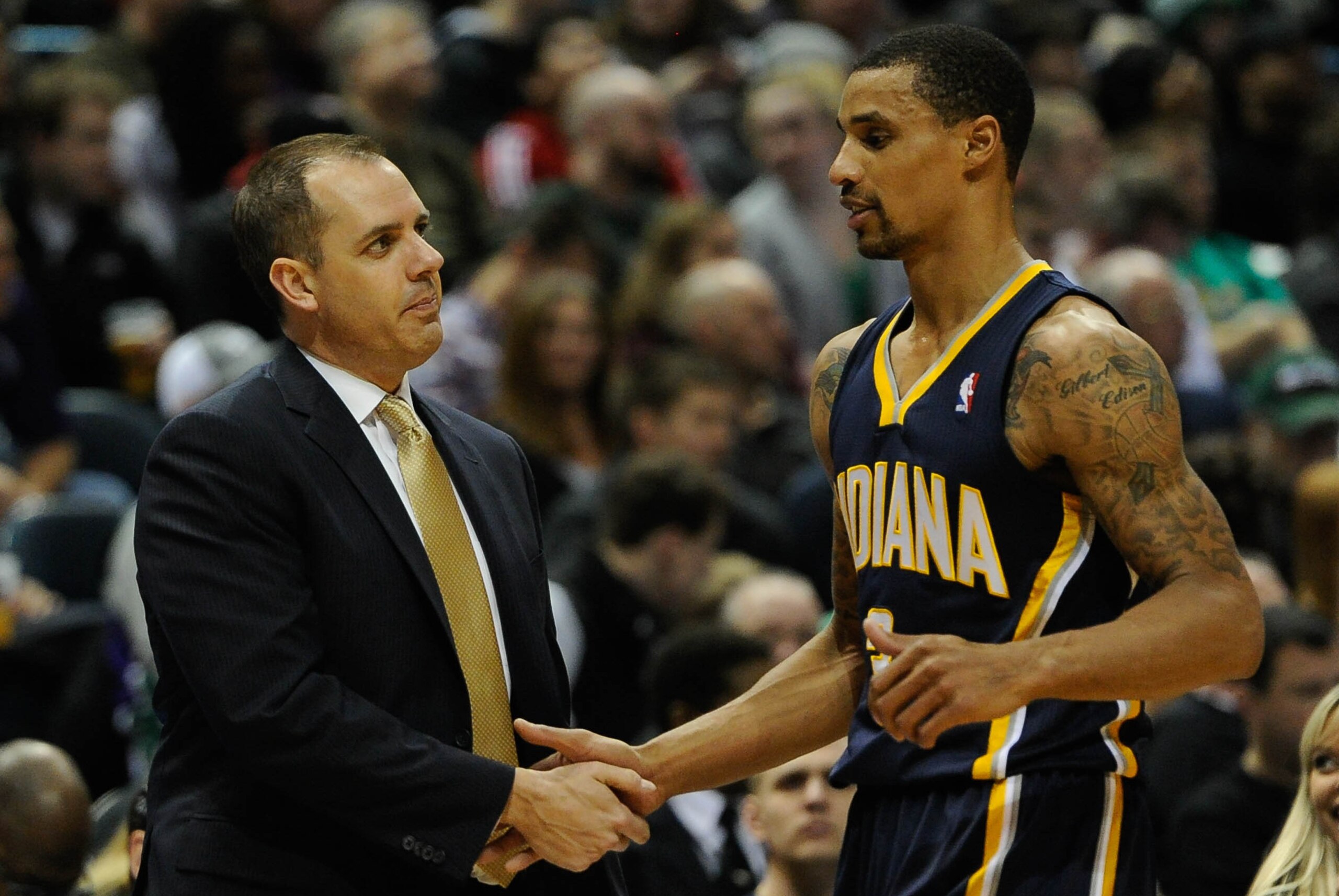 Feb 22, 2014; Milwaukee, WI, USA;   Indiana Pacers head coach Frank Vogel greets guard George Hill (3) after a substitution during the game against the Milwaukee Bucks at BMO Harris Bradley Center. The Pacers beat the Bucks 110-100. Mandatory Credit: Benn