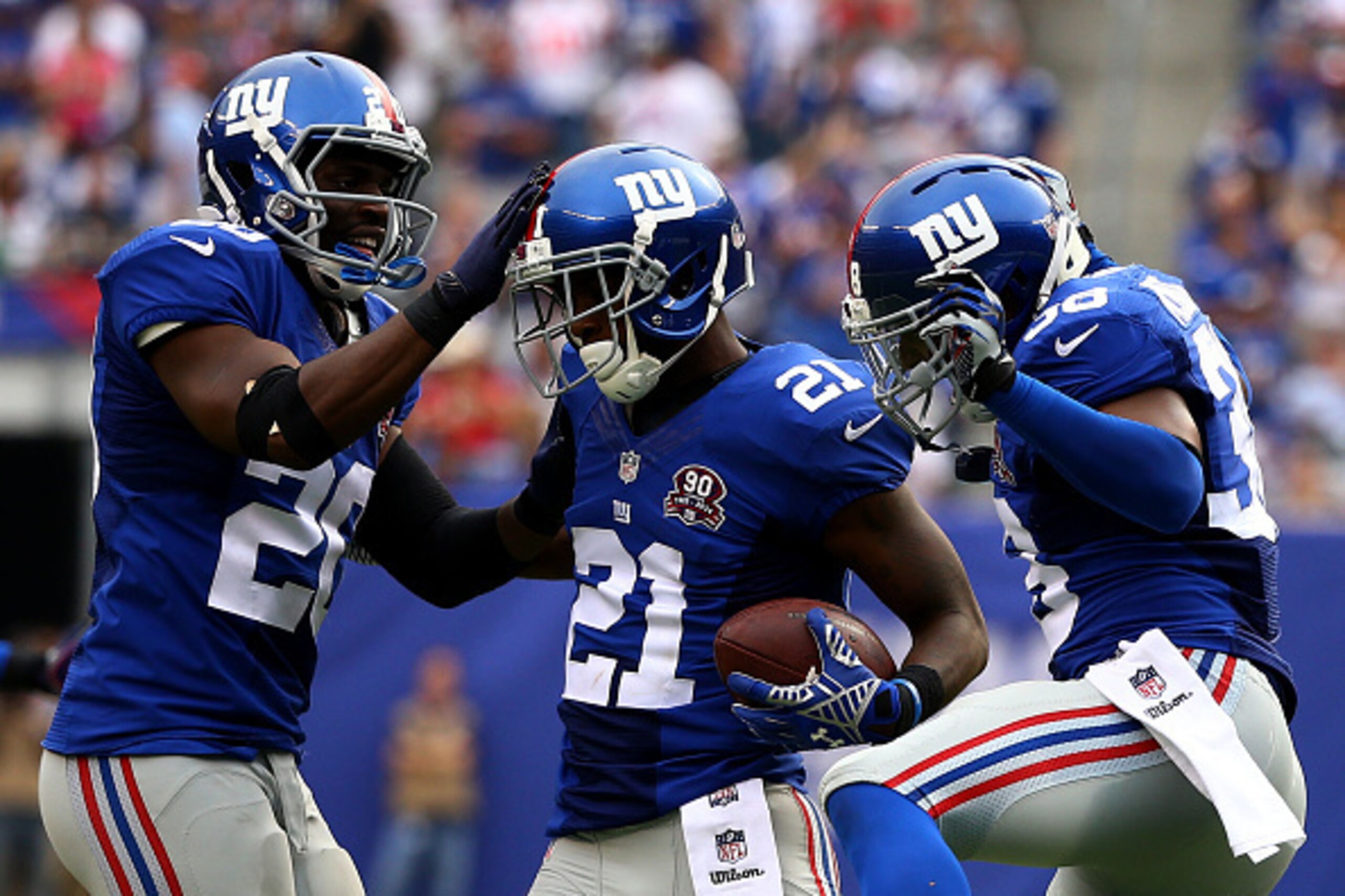 EAST RUTHERFORD, NJ - SEPTEMBER 21:  Dominique Rodgers-Cromartie #21 of the New York Giants celebrates his interception with teammates  Prince Amukamara #20 and  Trumaine McBride #38 in the fourth quarter against the Houston Texans at MetLife Stadium on S