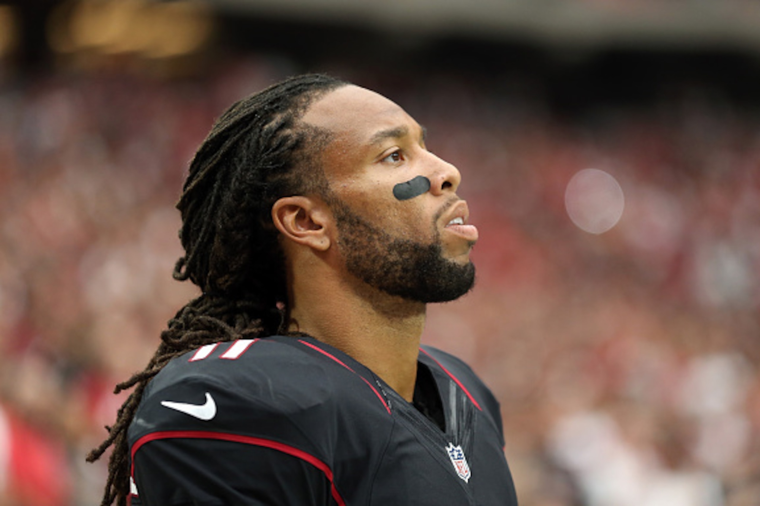 GLENDALE, AZ - SEPTEMBER 21:  Wide receiver Larry Fitzgerald #11 of the Arizona Cardinals watches from the sidelines during the NFL game against the San Francisco 49ers at the University of Phoenix Stadium on September 21, 2014 in Glendale, Arizona. The C