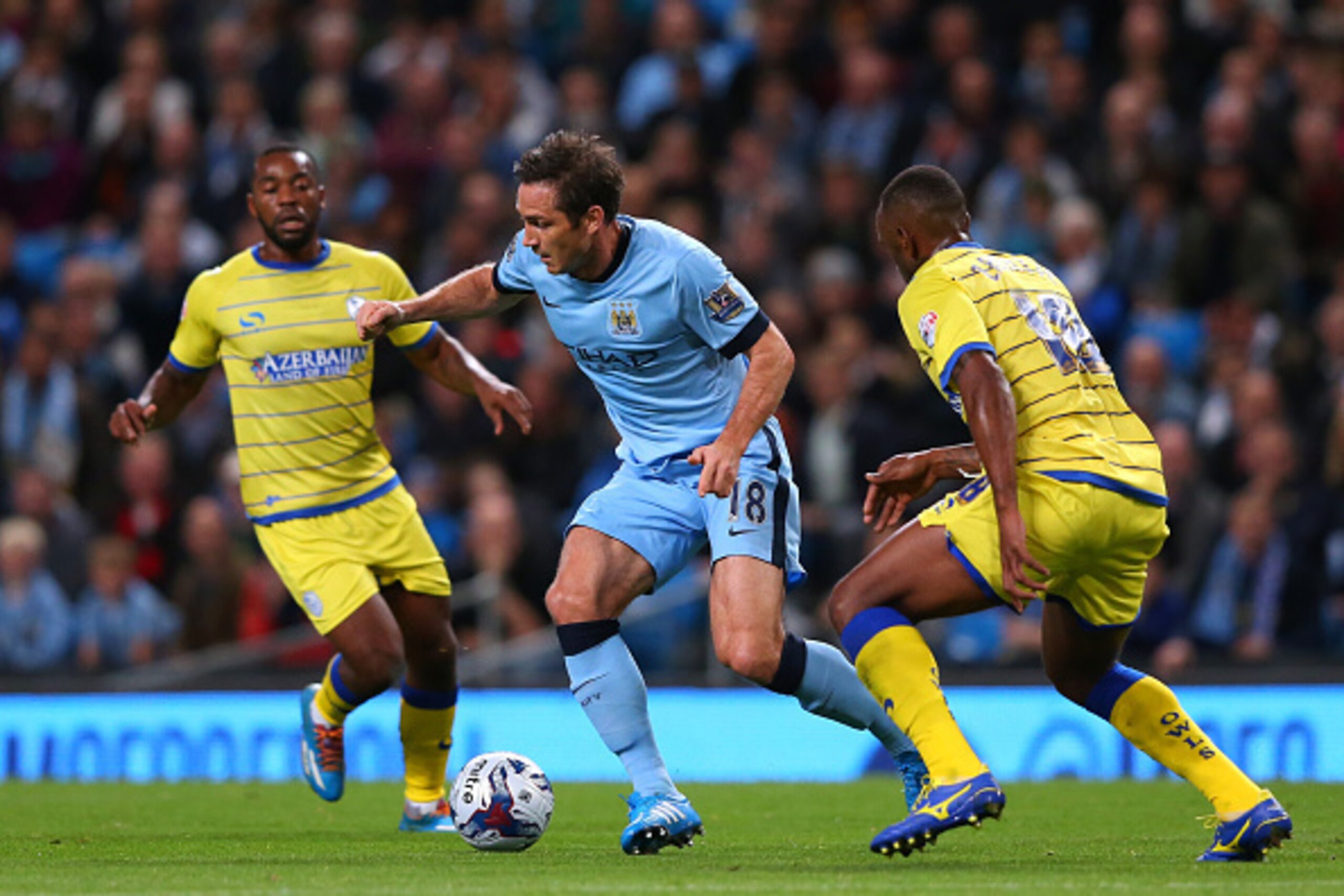 MANCHESTER, ENGLAND - SEPTEMBER 24:  Frank Lampard of Manchester City beats Kamil Zayatte of Sheffield Wednesday during the Capital One Cup Third Round match between Manchester City and Sheffield Wednesday at Etihad Stadium on September 24, 2014 in Manche