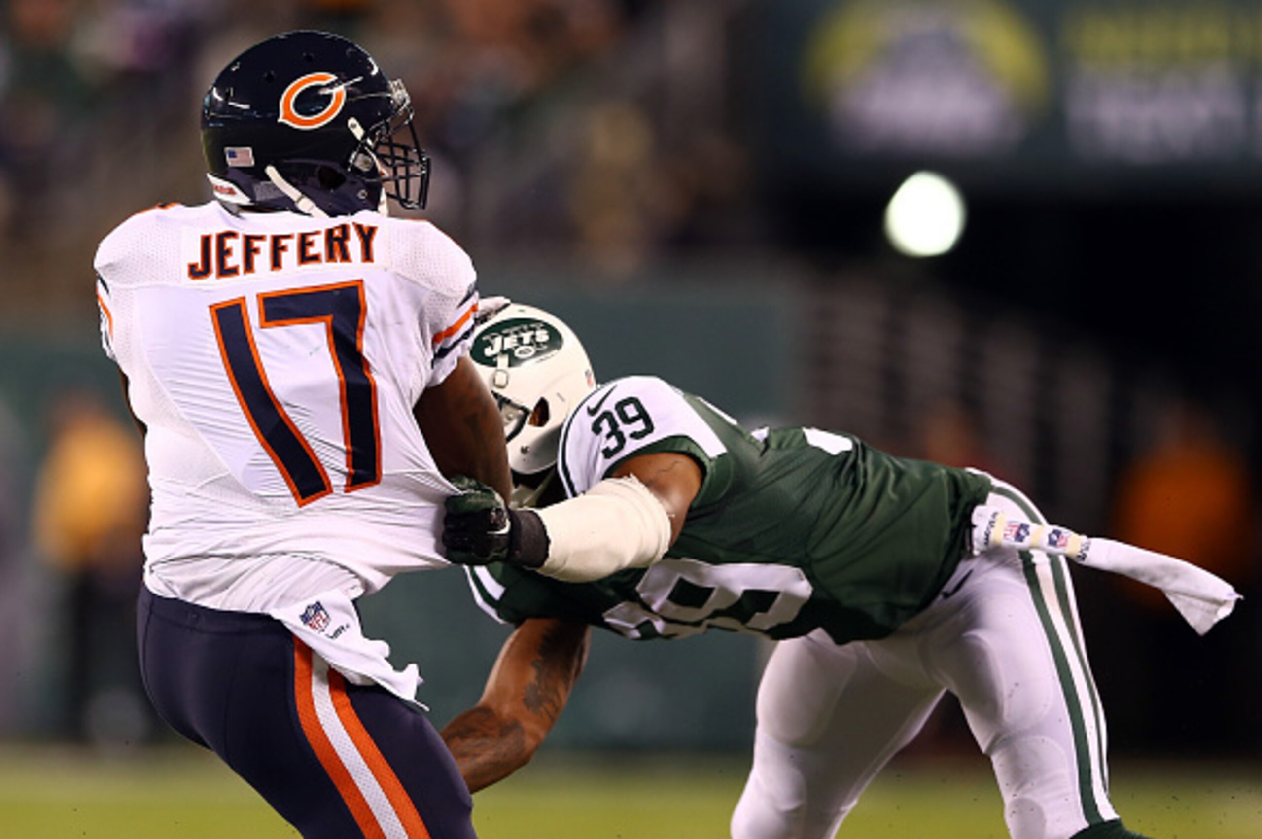 EAST RUTHERFORD, NJ - SEPTEMBER 22: Wide receiver Alshon Jeffery #17 of the Chicago Bears tries to avoid a tackle by free safety Antonio Allen #39 of the New York Jets during a game at MetLife Stadium on September 22, 2014 in East Rutherford, New Jersey. EAST RUTHERFORD, NJ - SEPTEMBER 22: Wide receiver Alshon Jeffery #17 of the Chicago Bears tries to avoid a tackle by free safety Antonio Allen #39 of the New York Jets during a game at MetLife Stadium on September 22, 2014 in East Rutherford, New Jersey.