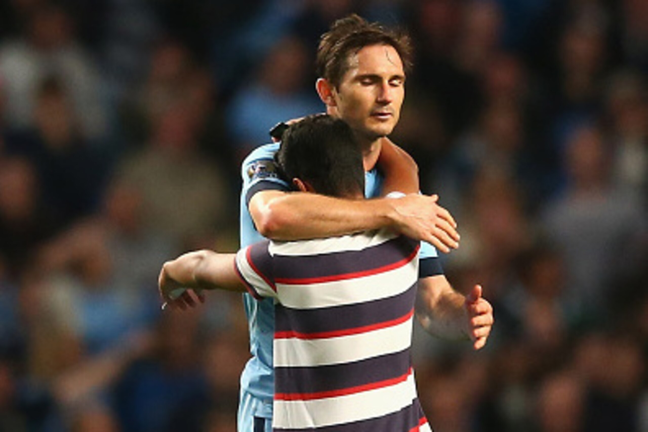 MANCHESTER, ENGLAND - SEPTEMBER 24:  A supporter of Manchester City enters the pitch to hug and take a 'selfie' of Frank Lampard as a security official looks on during the Capital One Cup Third Round match between Manchester City and Sheffield Wednesday a