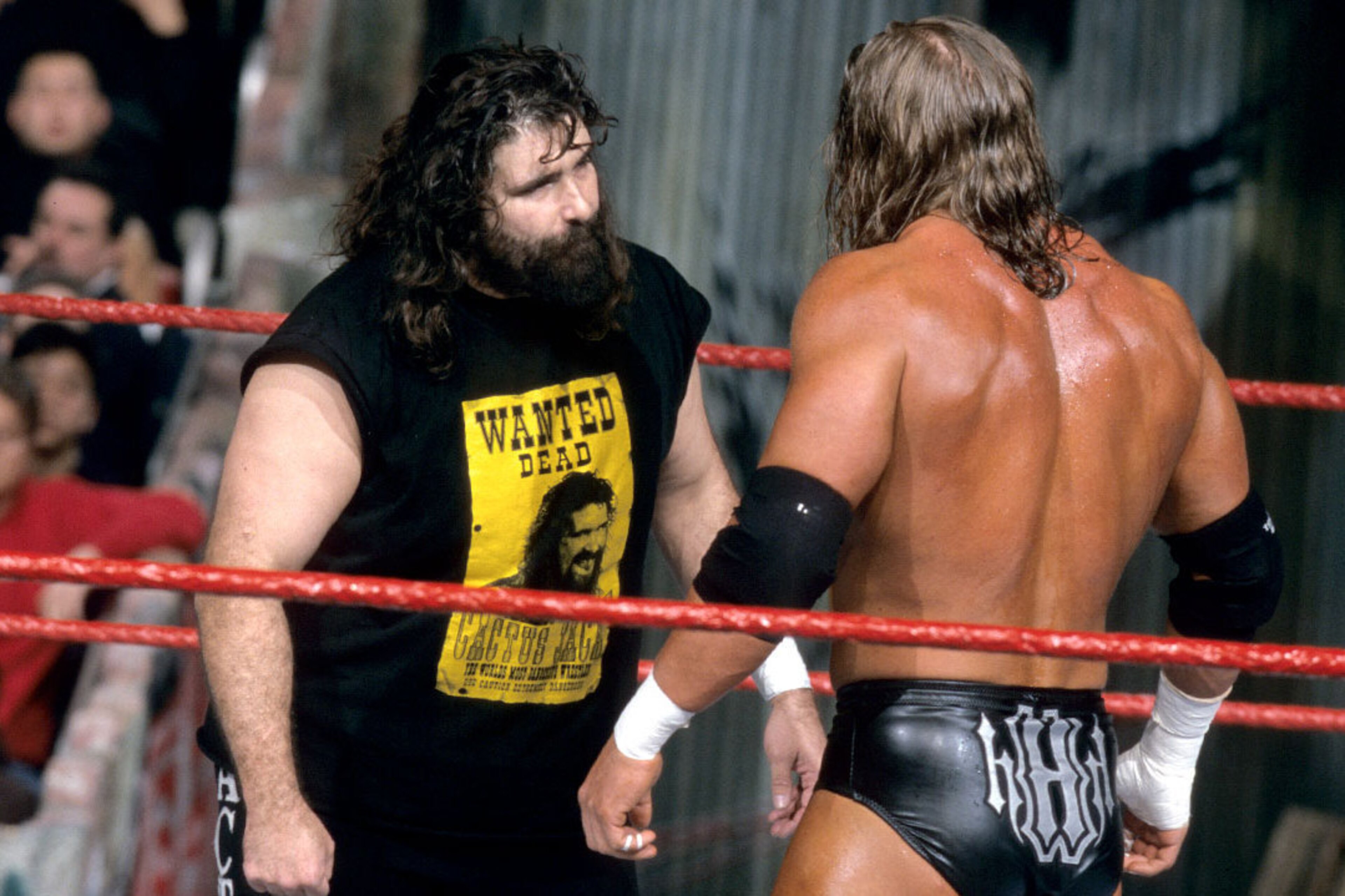Cactus Jack and Triple H stare each other down. Cactus Jack and Triple H stare each other down.