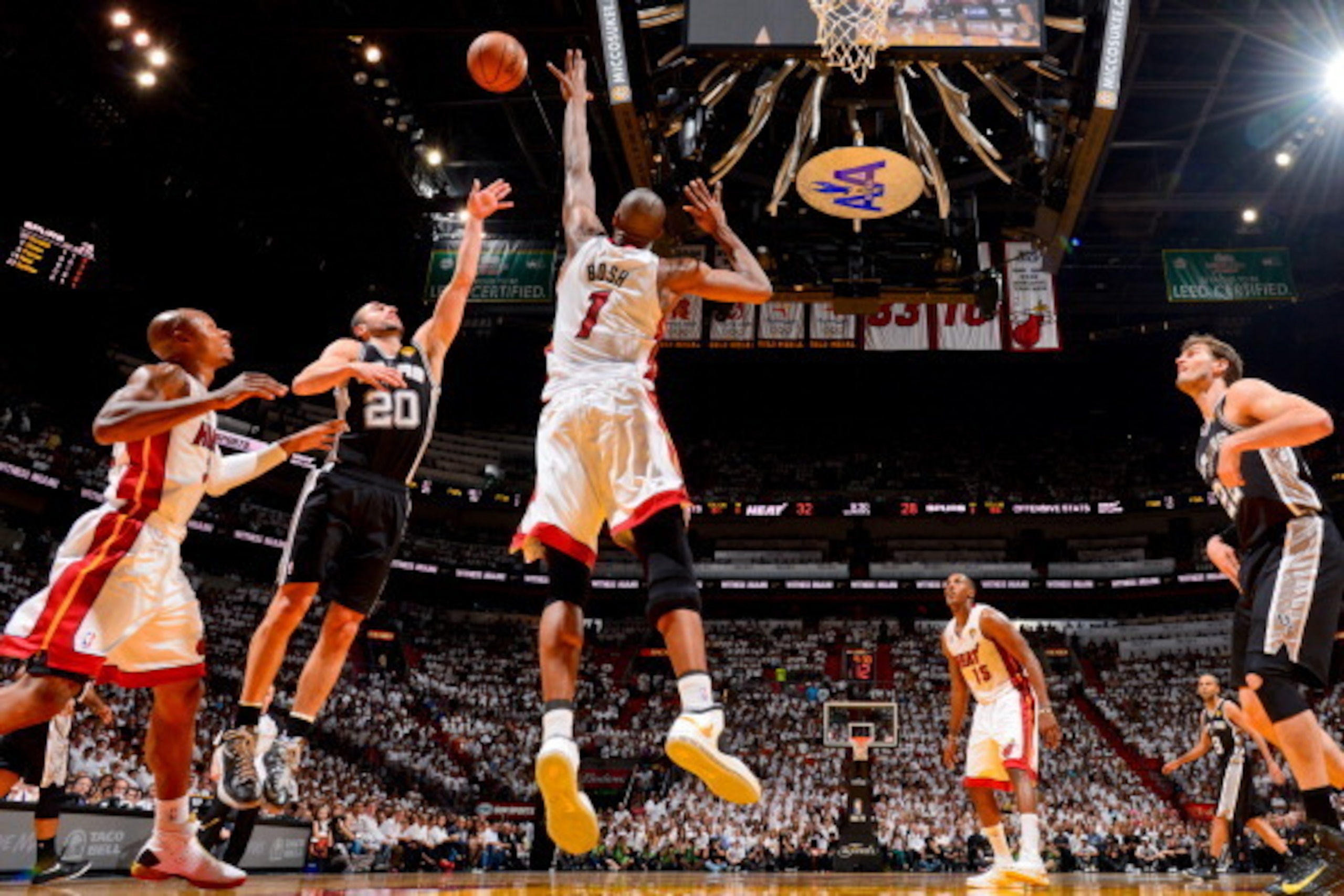 MIAMI, FL - JUNE 18: Manu Ginobili #20 of the San Antonio Spurs shoots a floater against Chris Bosh #1 of the Miami Heat during Game Six of the 2013 NBA Finals on June 18, 2013 at American Airlines Arena in Miami, Florida. NOTE TO USER: User expressly ack