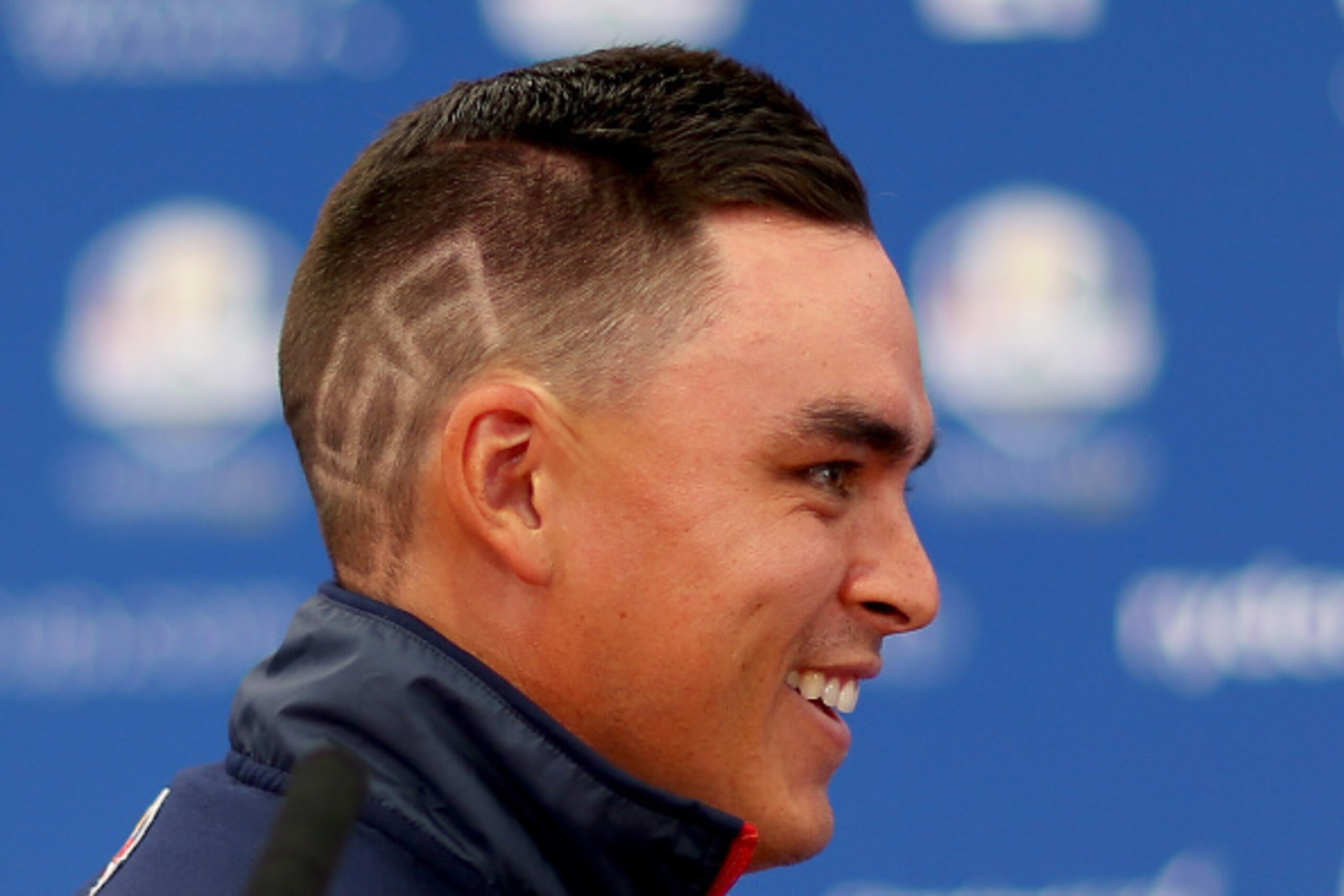 AUCHTERARDER, SCOTLAND - SEPTEMBER 24:  Rickie Fowler of the United States shows off the 'USA' haircut as he questions by the media ahead of the 2014 Ryder Cup on the PGA Centenary course at the Gleneagles Hotel on September 24, 2014 in Auchterarder, Scot