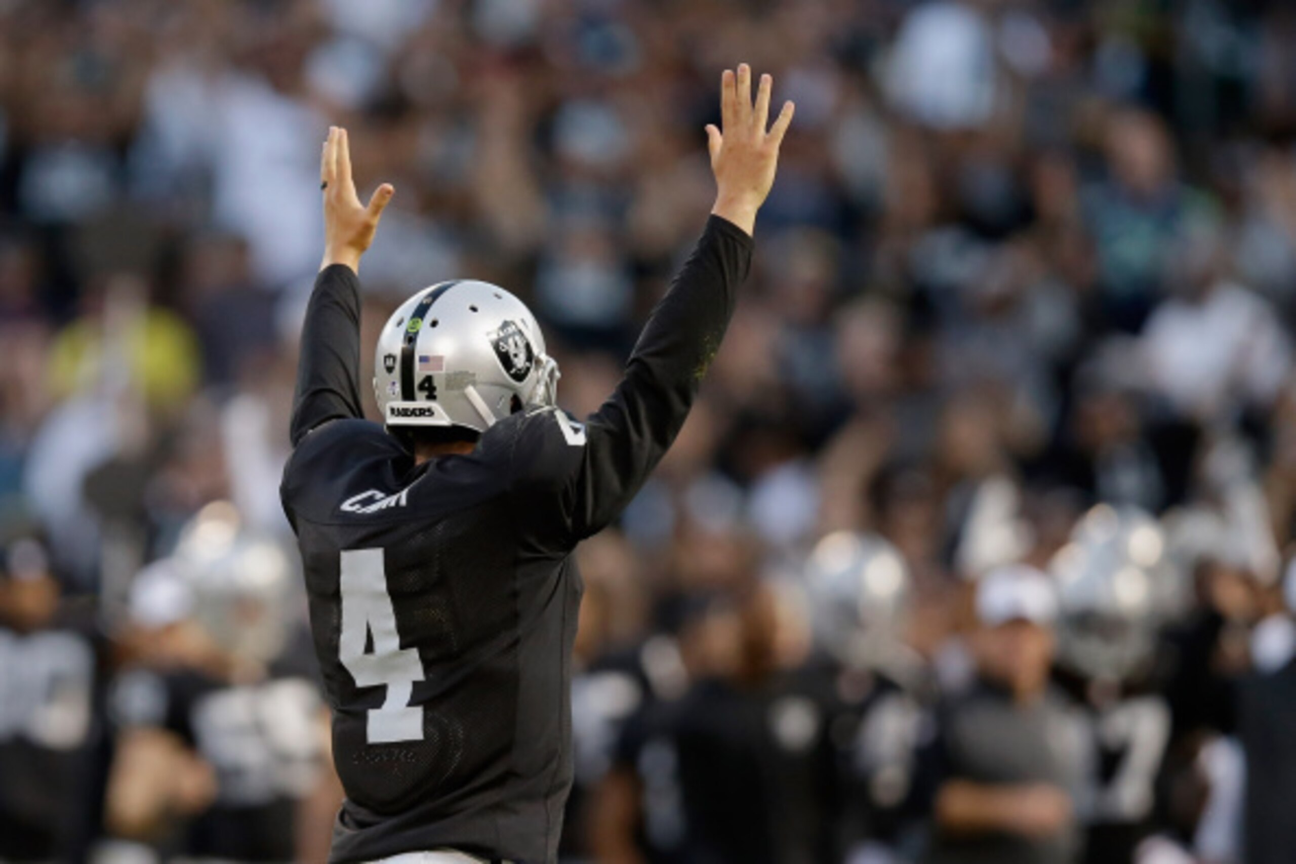 OAKLAND, CA - AUGUST 28: Quarterback Derek Carr #4 of the Oakland Raiders celebrates after a Raiders' touchdown against the Seattle Seahawks during a preseason game at O.co Coliseum on August 28, 2014 in Oakland, California.  (Photo by Ezra Shaw/Getty Ima