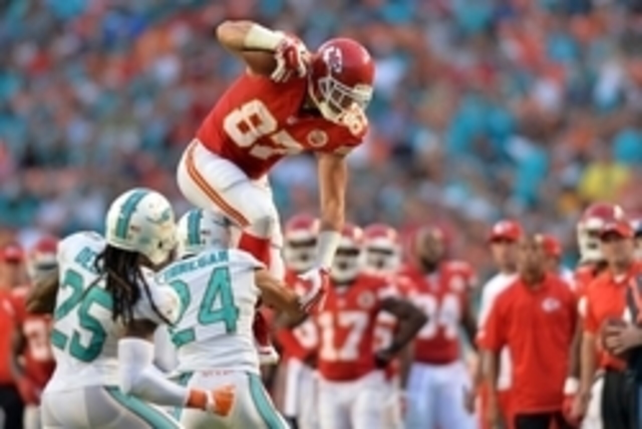 Sep 21, 2014; Miami Gardens, FL, USA; Kansas City Chiefs tight end Travis Kelce (87) leaps over Miami Dolphins cornerback Cortland Finnegan (24) during the second half at Sun Life Stadium. Chiefs won 34-15. Mandatory Credit: Steve Mitchell-USA TODAY Sport