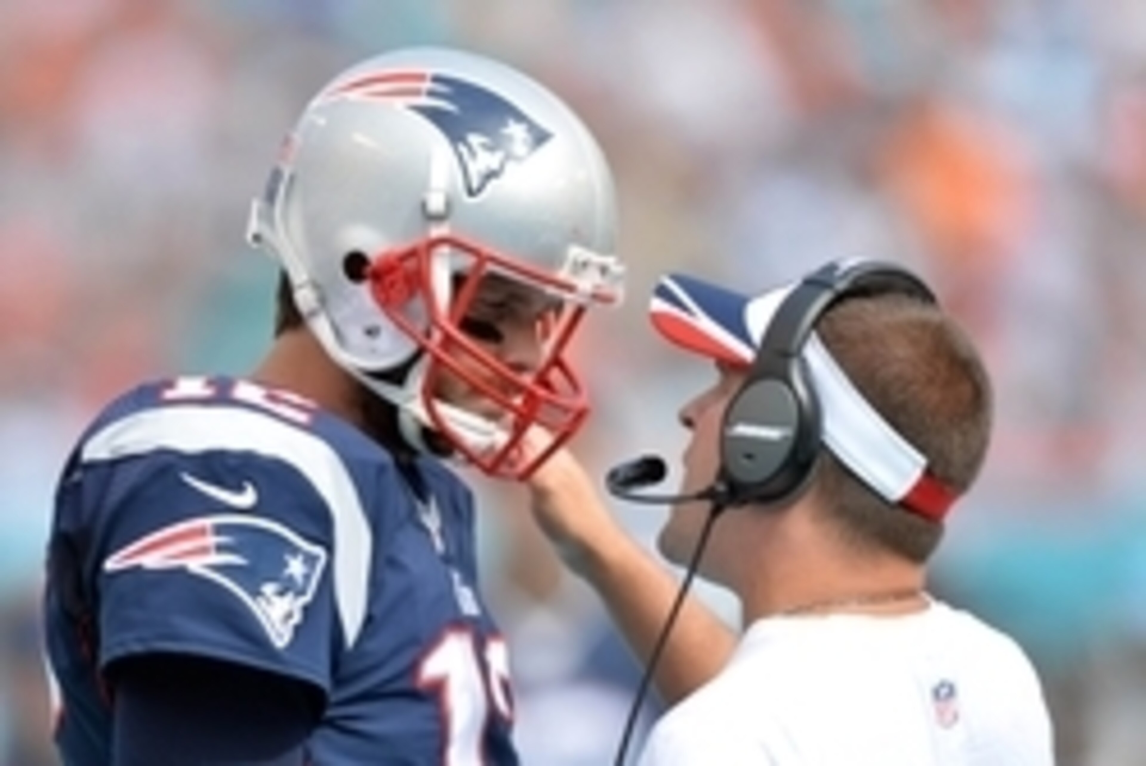 Sep 7, 2014; Miami Gardens, FL, USA; New England Patriots quarterback Tom Brady (left) listens to offensive coordinator quarterbacks coach Josh McDaniels (right) during the second half against the Miami Dolphins at Sun Life Stadium. The Dolphins won 33-20