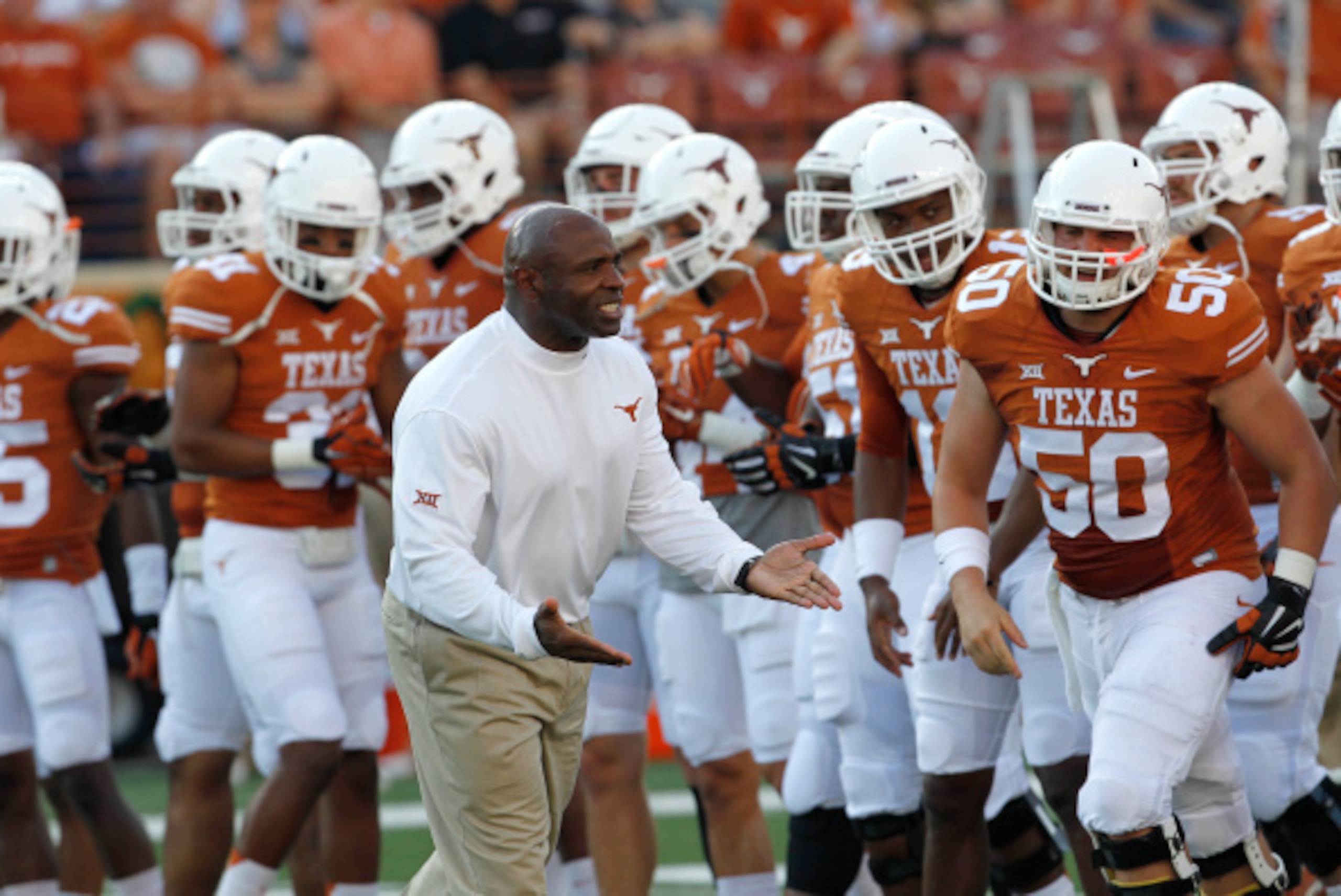 AUSTIN, TX - SEPTEMBER 6: Head coach Charlie Strong of the Texas Longhorns encourages his team in warmups before playing the BYU Cougars on September 6, 2014 at Darrell K Royal-Texas Memorial Stadium in Austin, Texas. (Photo by Chris Covatta/Getty Images)