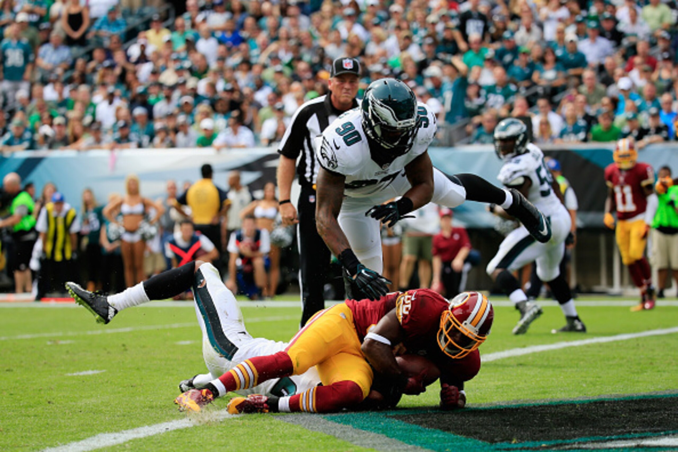 PHILADELPHIA, PA - SEPTEMBER 21: Pierre Garcon #88 of the Washington Redskins scores a touchdown against  Marcus Smith #90 of the Philadelphia Eagles in the first quarter of the game at Lincoln Financial Field on September 21, 2014 in Philadelphia, Pennsy