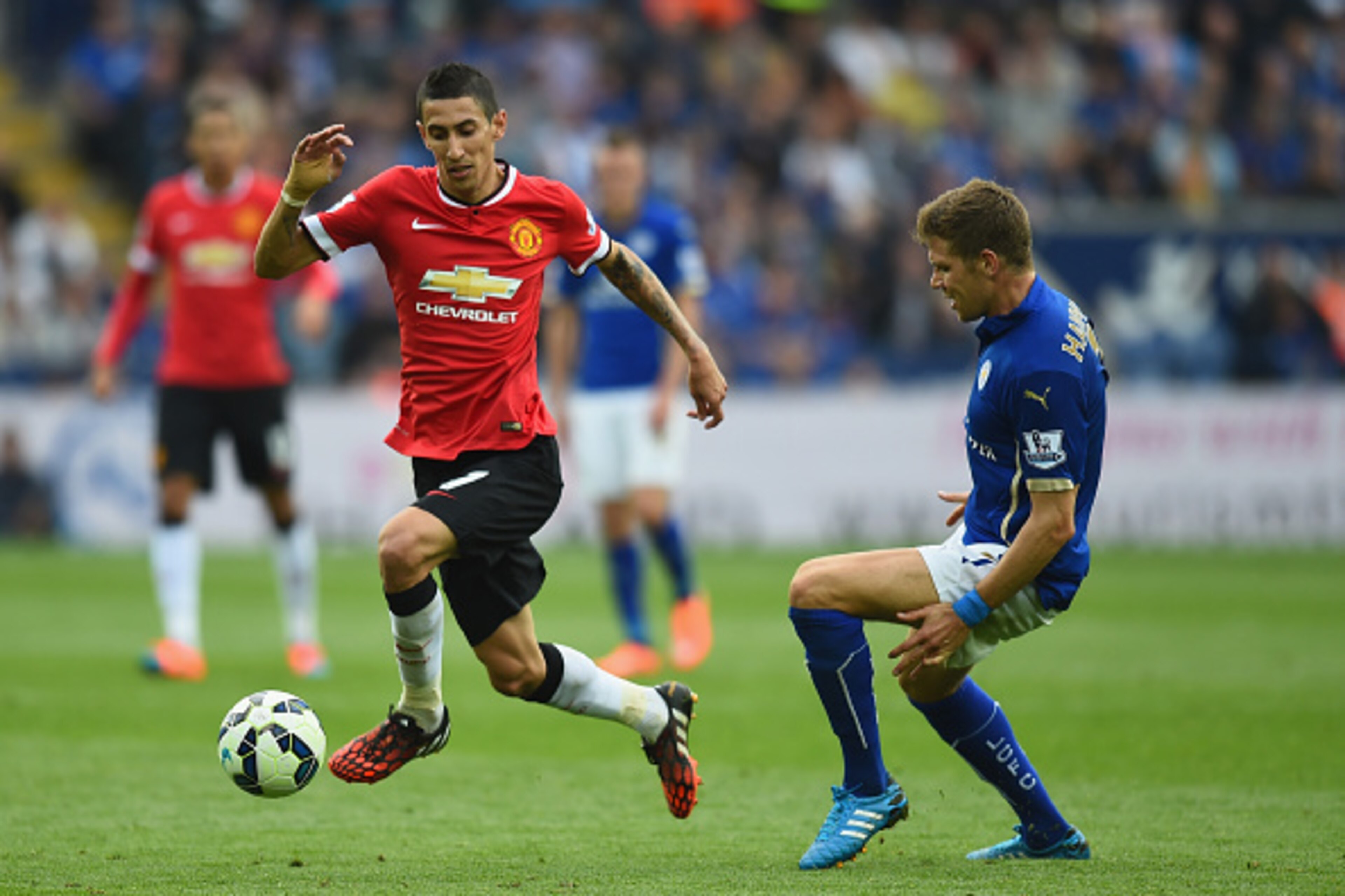 LEICESTER, ENGLAND - SEPTEMBER 21:  Angel Di Maria of Manchester United gets past Dean Hammond of Leicester during the Barclays Premier League match between Leicester City and Manchester United at The King Power Stadium on September 21, 2014 in Leicester,