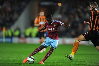 HULL, ENGLAND - SEPTEMBER 15:  West Ham player Enner Valencia (l) shoots past Michael Dawson of Hull for the first West Ham goal during the Barclays Premier League match between Hull City and West Ham United at KC Stadium on September 15, 2014 in Hull, En